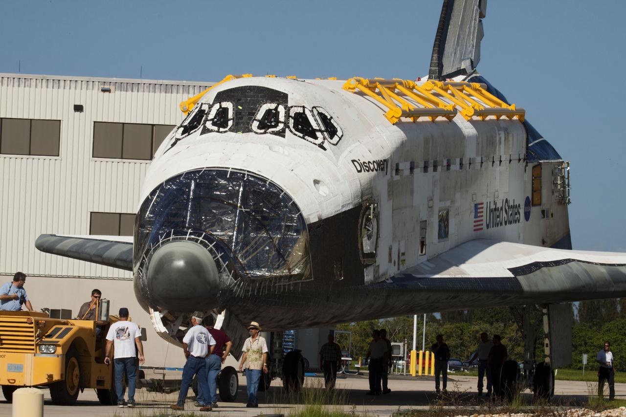 CAPE CANAVERAL, Fla. -- At NASA's Kennedy Space Center in Florida, space shuttle Discovery -- its nose encased in protective plastic, its cockpit windows covered, and strongbacks attached to its payload bay doors -- rolls out of Orbiter Processing Facility-2, or OPF-2, on its move to the Vehicle Assembly Building, or VAB. Discovery will be stored inside the VAB for approximately one month while shuttle Atlantis undergoes processing in OPF-2 following its final mission, STS-135. Discovery flew its 39th and final mission, STS-133, in February and March 2011, and currently is being prepared for public display at the Smithsonian's National Air and Space Museum Steven F. Udvar-Hazy Center in Virginia. For more information about Discovery's Transition and Retirement, visit www.nasa.gov/mission_pages/shuttle/launch/discovery_rss_collection_archive_1.html. Photo credit: NASA/Ken Thornsley