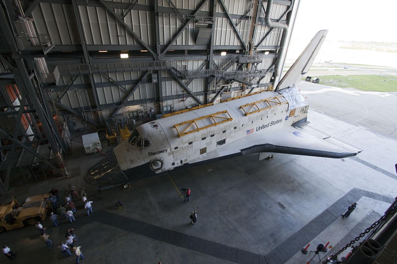 CAPE CANAVERAL, Fla. -- At NASA's Kennedy Space Center in Florida, space shuttle Discovery -- its nose encased in protective plastic, its cockpit windows covered, and strongbacks attached to its payload bay doors -- is welcomed into the Vehicle Assembly Building, or VAB, after its roll from Orbiter Processing Facility-2, or OPF-2. Discovery will be stored inside the VAB for approximately one month while shuttle Atlantis undergoes processing in OPF-2 following its final mission, STS-135. Discovery flew its 39th and final mission, STS-133, in February and March 2011, and currently is being prepared for public display at the Smithsonian's National Air and Space Museum Steven F. Udvar-Hazy Center in Virginia. For more information about Discovery's Transition and Retirement, visit www.nasa.gov/mission_pages/shuttle/launch/discovery_rss_collection_archive_1.html. Photo credit: NASA/Ken Thornsley
