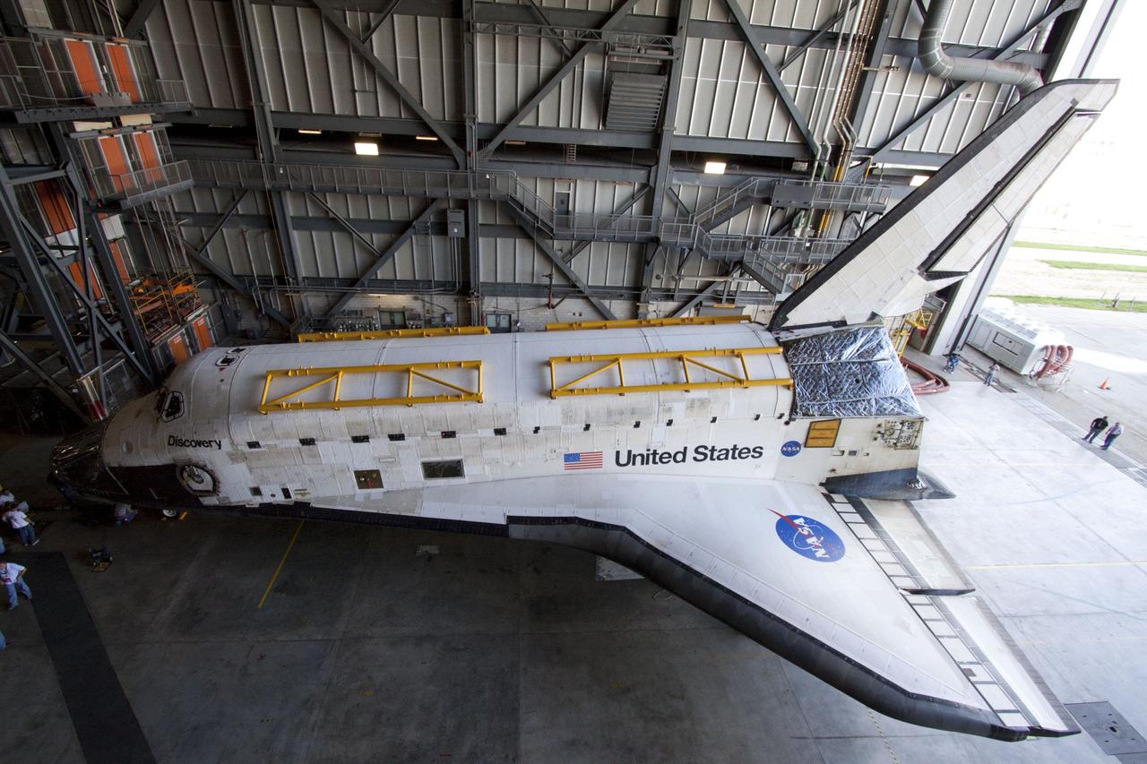 CAPE CANAVERAL, Fla. -- At NASA's Kennedy Space Center in Florida, space shuttle Discovery -- its nose encased in protective plastic, its cockpit windows covered, and strongbacks attached to its payload bay doors -- finds shelter in the Vehicle Assembly Building, or VAB, after rolling from Orbiter Processing Facility-2, or OPF-2. Discovery will be stored inside the VAB for approximately one month while shuttle Atlantis undergoes processing in OPF-2 following its final mission, STS-135. Discovery flew its 39th and final mission, STS-133, in February and March 2011, and currently is being prepared for public display at the Smithsonian's National Air and Space Museum Steven F. Udvar-Hazy Center in Virginia. For more information about Discovery's Transition and Retirement, visit www.nasa.gov/mission_pages/shuttle/launch/discovery_rss_collection_archive_1.html. Photo credit: NASA/Ken Thornsley