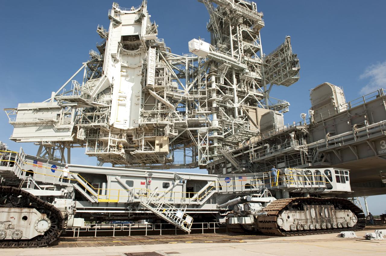 CAPE CANAVERAL, Fla. -- At NASA's Kennedy Space Center in Florida, Mobile Launcher Platform-3 (MLP), which supported space shuttle Atlantis for its final flight to the International Space Station on the STS-135 mission, is being prepared for its last journey from Launch Pad 39A to the Vehicle Assembly Building (VAB). Here, workers are moving a massive crawler-transporter under the MLP -- the last mobile launcher platform to launch a shuttle.               For more than 40 years, the MLPs have traveled between the massive VAB to both launch pads at Launch Complex 39, and then returned to the VAB for future use. MLP-3 was first used to launch Columbia on the STS-32 mission on Jan. 9, 1990. Photo credit: NASA/Kim Shiflett