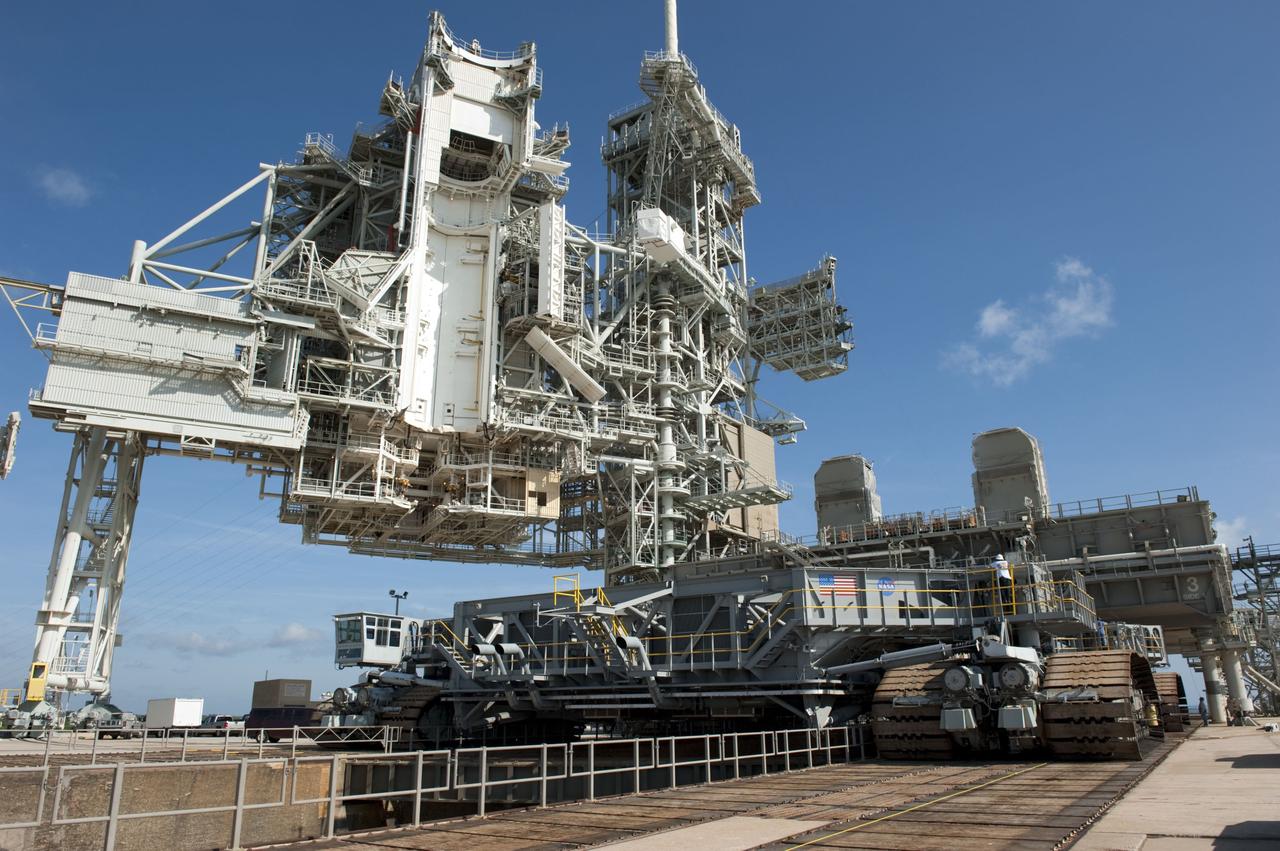 CAPE CANAVERAL, Fla. -- At NASA's Kennedy Space Center in Florida, Mobile Launcher Platform-3 (MLP), which supported space shuttle Atlantis for its final flight to the International Space Station on the STS-135 mission, is being prepared for its last journey from Launch Pad 39A to the Vehicle Assembly Building (VAB). Here, workers are moving a massive crawler-transporter under the MLP -- the last mobile launcher platform to launch a shuttle.                 For more than 40 years, the MLPs have traveled between the massive VAB to both launch pads at Launch Complex 39, and then returned to the VAB for future use. MLP-3 was first used to launch Columbia on the STS-32 mission on Jan. 9, 1990. Photo credit: NASA/Kim Shiflett