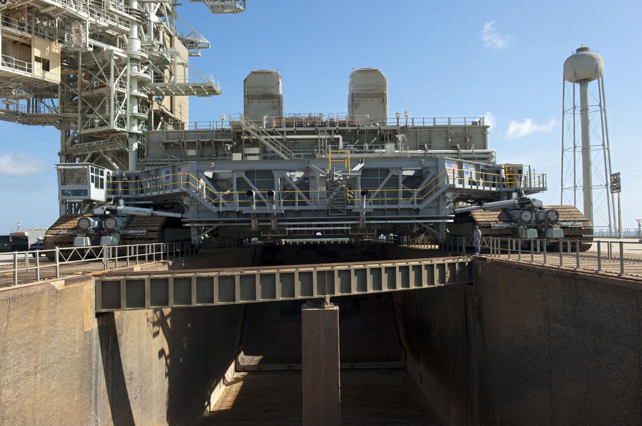 CAPE CANAVERAL, Fla. -- At NASA's Kennedy Space Center in Florida, Mobile Launcher Platform-3 (MLP), which supported space shuttle Atlantis for its final flight to the International Space Station on the STS-135 mission, is being prepared for its last journey from Launch Pad 39A to the Vehicle Assembly Building (VAB). Here, workers are moving a massive crawler-transporter under the MLP -- the last mobile launcher platform to launch a shuttle.                 For more than 40 years, the MLPs have traveled between the massive VAB to both launch pads at Launch Complex 39, and then returned to the VAB for future use. MLP-3 was first used to launch Columbia on the STS-32 mission on Jan. 9, 1990. Photo credit: NASA/Kim Shiflett