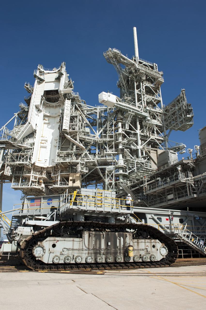 CAPE CANAVERAL, Fla. -- At NASA's Kennedy Space Center in Florida, Mobile Launcher Platform-3 (MLP), which supported space shuttle Atlantis for its final flight to the International Space Station on the STS-135 mission, is being prepared for its last journey from Launch Pad 39A to the Vehicle Assembly Building (VAB). Here, workers are moving a massive crawler-transporter under the MLP -- the last mobile launcher platform to launch a shuttle.                 For more than 40 years, the MLPs have traveled between the massive VAB to both launch pads at Launch Complex 39, and then returned to the VAB for future use. MLP-3 was first used to launch Columbia on the STS-32 mission on Jan. 9, 1990. Photo credit: NASA/Kim Shiflett