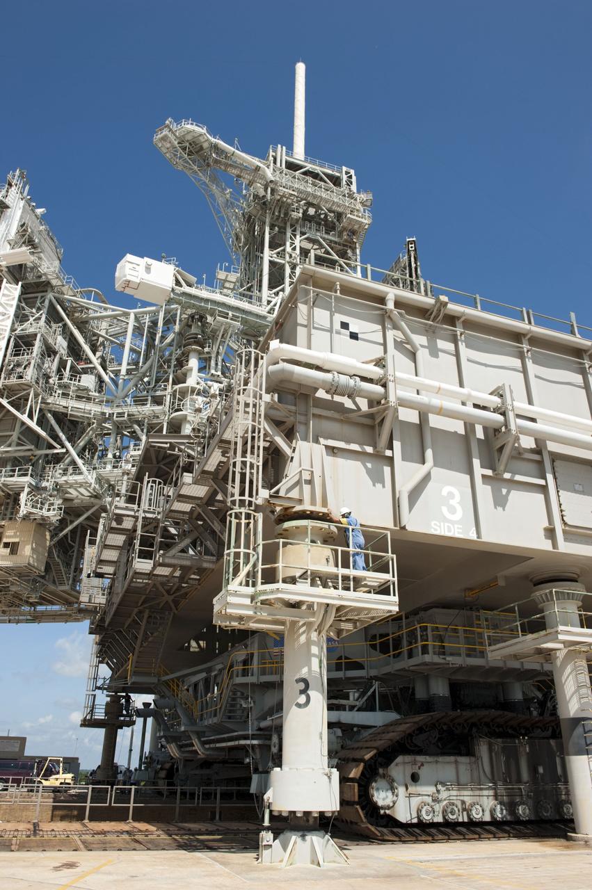CAPE CANAVERAL, Fla. -- At NASA's Kennedy Space Center in Florida, Mobile Launcher Platform-3 (MLP), which supported space shuttle Atlantis for its final flight to the International Space Station on the STS-135 mission, is being prepared for its last journey from Launch Pad 39A to the Vehicle Assembly Building (VAB). Here, workers have moved a massive crawler-transporter under the MLP -- the last mobile launcher platform to launch a shuttle.                 For more than 40 years, the MLPs have traveled between the massive VAB to both launch pads at Launch Complex 39, and then returned to the VAB for future use. MLP-3 was first used to launch Columbia on the STS-32 mission on Jan. 9, 1990. Photo credit: NASA/Kim Shiflett