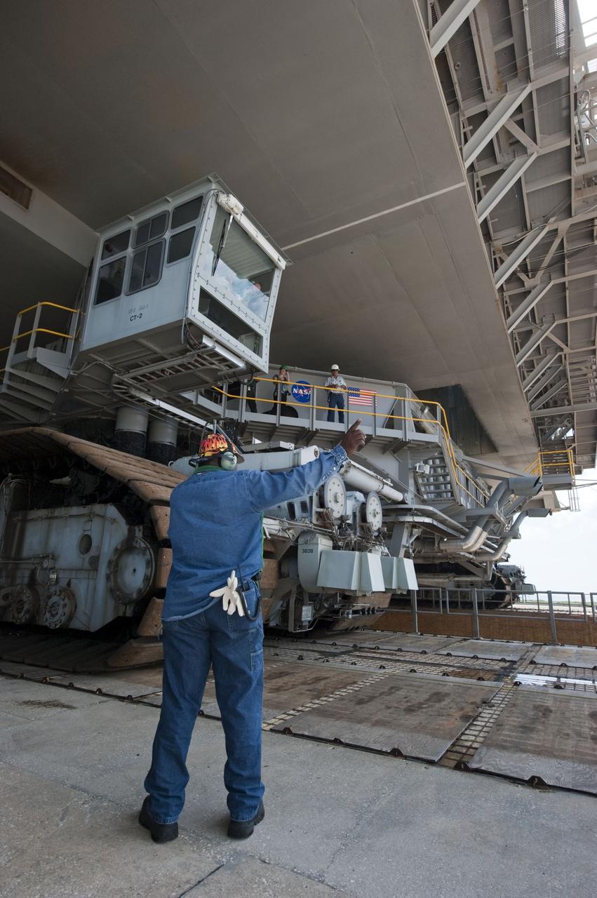 CAPE CANAVERAL, Fla. -- At NASA's Kennedy Space Center in Florida, Mobile Launcher Platform-3 (MLP), which supported space shuttle Atlantis for its final flight to the International Space Station on the STS-135 mission, is being prepared for its last journey from Launch Pad 39A to the Vehicle Assembly Building (VAB). Here, workers check the position of the massive crawler-transporter positioned under the MLP -- the last mobile launcher platform to launch a shuttle.                   For more than 40 years, the MLPs have traveled between the massive VAB to both launch pads at Launch Complex 39, and then returned to the VAB for future use. MLP-3 was first used to launch Columbia on the STS-32 mission on Jan. 9, 1990. Photo credit: NASA/Kim Shiflett