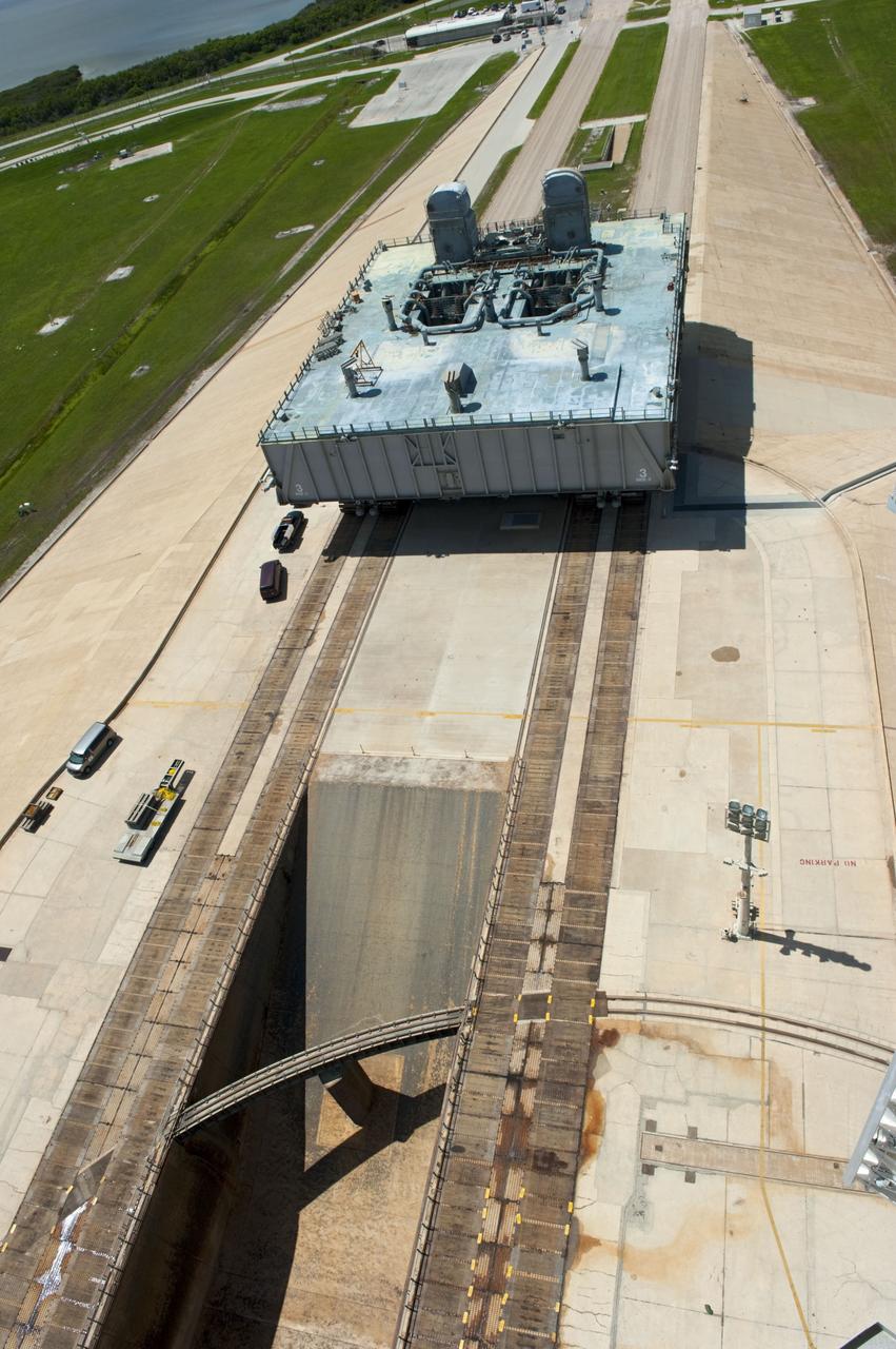 CAPE CANAVERAL, Fla. -- At NASA's Kennedy Space Center in Florida, Mobile Launcher Platform-3 (MLP), which supported space shuttle Atlantis for its final flight to the International Space Station on the STS-135 mission, is taking its last journey from Launch Pad 39A to the Vehicle Assembly Building (VAB). A massive crawler-transporter positioned under the MLP -- the last mobile launcher platform to launch a shuttle, begins the trek back to the VAB.                  For more than 40 years, the MLPs have traveled between the massive VAB to both launch pads at Launch Complex 39, and then returned to the VAB for future use. MLP-3 was first used to launch Columbia on the STS-32 mission on Jan. 9, 1990. Photo credit: NASA/Kim Shiflett