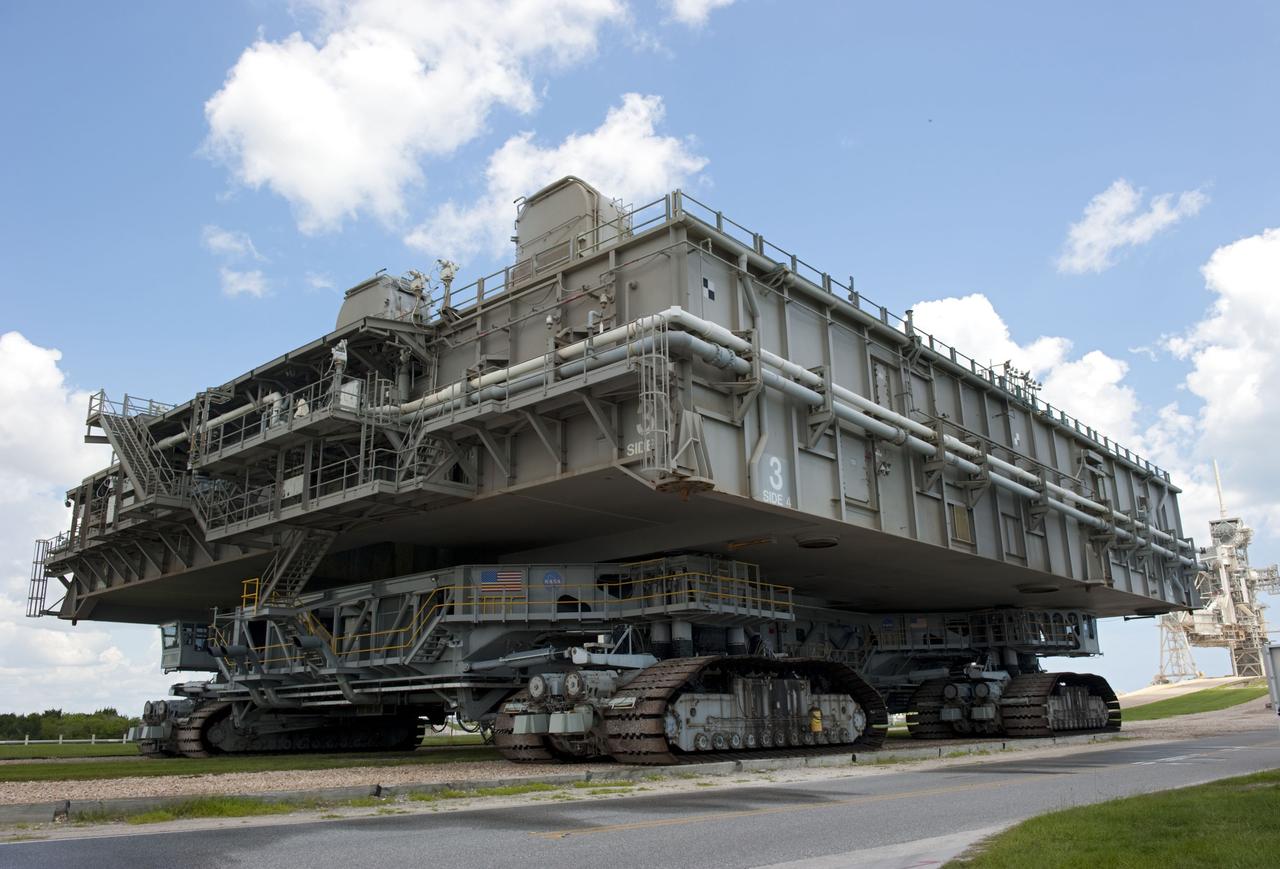CAPE CANAVERAL, Fla. -- At NASA's Kennedy Space Center in Florida, Mobile Launcher Platform-3 (MLP), which supported space shuttle Atlantis for its final flight to the International Space Station on the STS-135 mission, is taking its last journey from Launch Pad 39A to the Vehicle Assembly Building (VAB). A massive crawler-transporter positioned under the MLP -- the last mobile launcher platform to launch a shuttle, begins the trek back to the VAB.                    For more than 40 years, the MLPs have traveled between the massive VAB to both launch pads at Launch Complex 39, and then returned to the VAB for future use. MLP-3 was first used to launch Columbia on the STS-32 mission on Jan. 9, 1990. Photo credit: NASA/Kim Shiflett