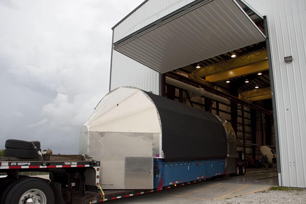 CAPE CANAVERAL, Fla. -- The second stage for the Space Exploration Technologies Corp., or SpaceX, Falcon 9 rocket is delivered to the SpaceX hangar at Pad 40 at Cape Canaveral Air Force Station in Florida.             The Falcon 9 rocket will launch a second Dragon spacecraft, called Dragon C2, in late 2011. The mission will demonstrate proximity operations during an approach within six miles of the International Space Station. The company is building the Dragon to fly on resupply missions to the station. SpaceX was awarded procurement for three demonstration flights under the Commercial Orbital Transportation Services, or COTS, program managed by NASA's Johnson Space Center in Houston. The SpaceX contract provides for 12 missions to resupply the station from 2011 through 2015. Photo credit: NASA/Jim Grossmann