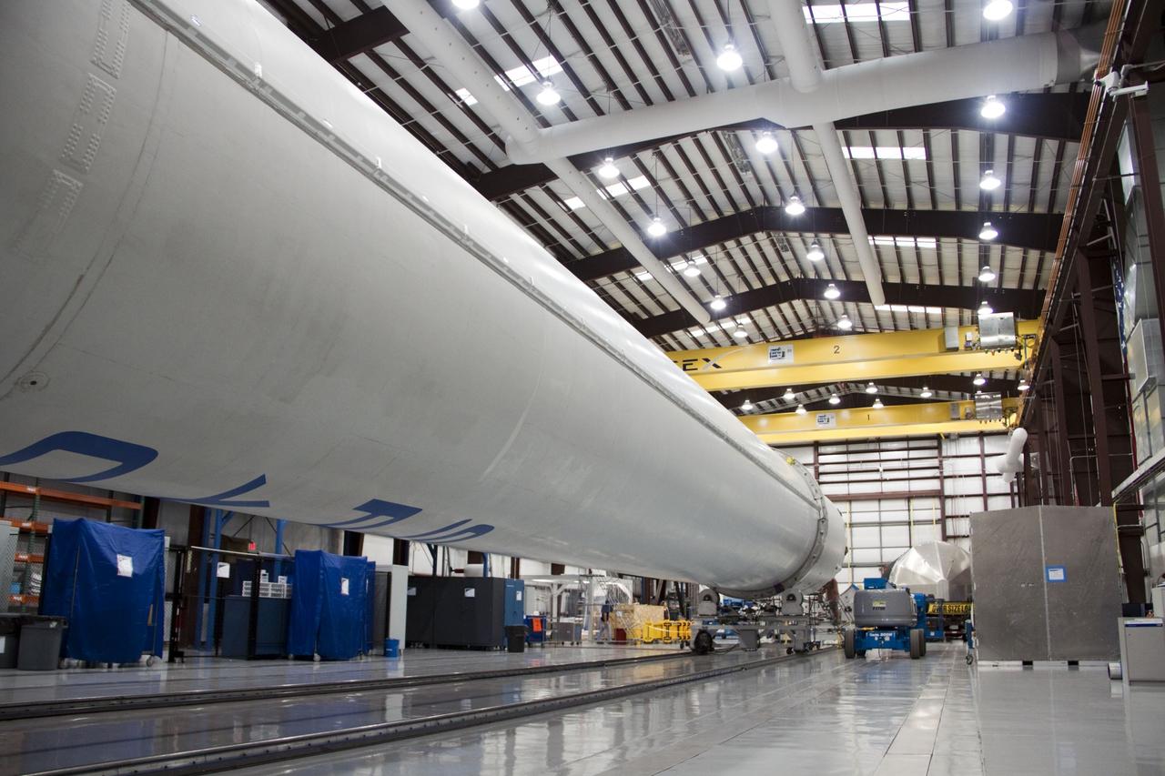 CAPE CANAVERAL, Fla. -- The second stage for the Space Exploration Technologies Corp., or SpaceX, Falcon 9 rocket is delivered to the SpaceX hangar at Pad 40 at Cape Canaveral Air Force Station in Florida. Also seen here in the foreground is the first stage of the Falcon 9.  The Falcon 9 rocket will launch a second Dragon spacecraft, called Dragon C2, in late 2011. The mission will demonstrate proximity operations during an approach within six miles of the International Space Station. The company is building the Dragon to fly on resupply missions to the station. SpaceX was awarded procurement for three demonstration flights under the Commercial Orbital Transportation Services, or COTS, program managed by NASA's Johnson Space Center in Houston. The SpaceX contract provides for 12 missions to resupply the station from 2011 through 2015. Photo credit: NASA/Jim Grossmann