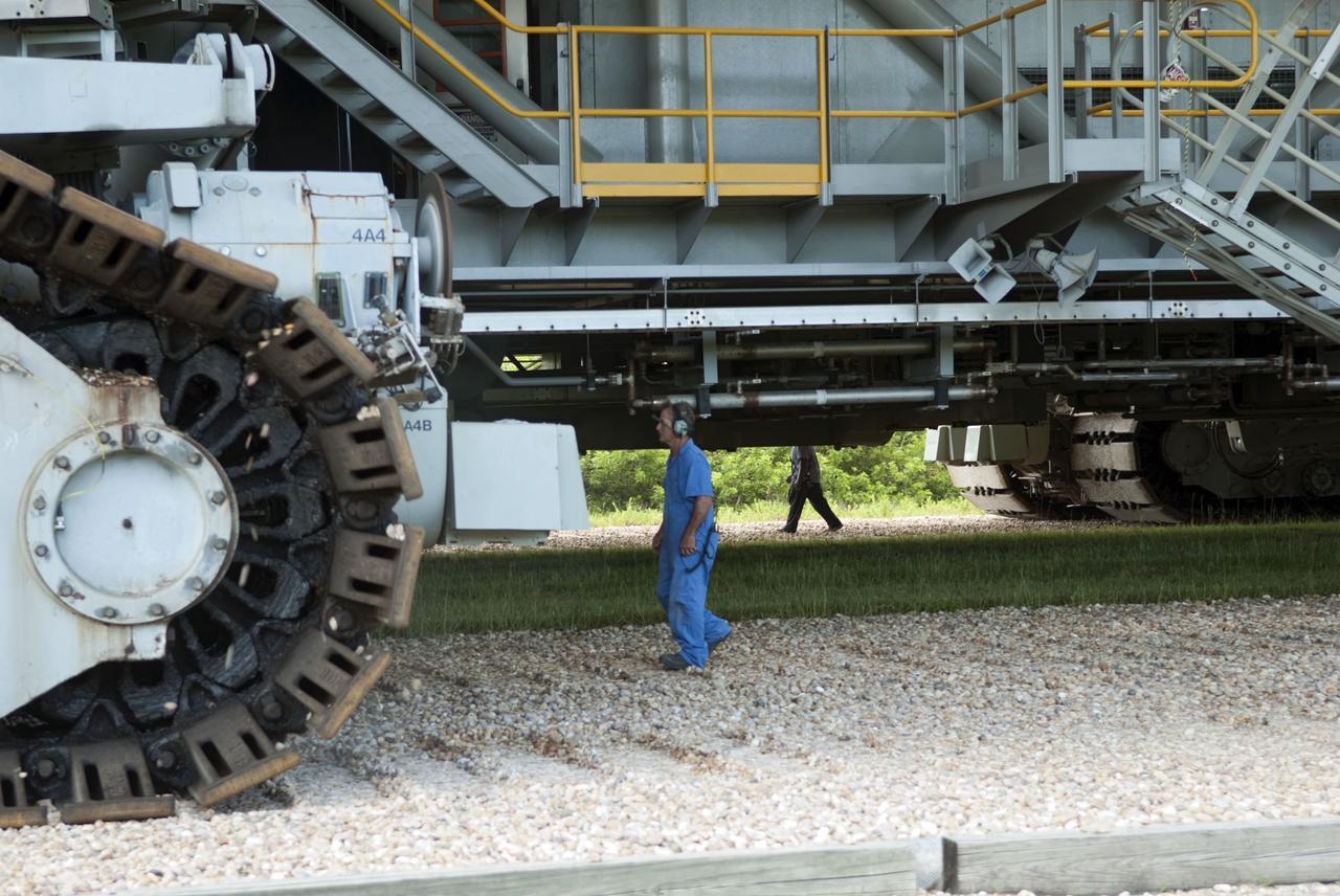CAPE CANAVERAL, Fla. -- At NASA's Kennedy Space Center in Florida, workers accompany Mobile Launcher Platform-3 (MLP), which supported space shuttle Atlantis for its final flight to the International Space Station on the STS-135 mission, while making its last journey from Launch Pad 39A back to the Vehicle Assembly Building (VAB) atop a massive crawler-transporter. For more than 40 years, the MLPs have traveled between the VAB to both launch pads at Launch Complex 39, and then returned to the VAB for future use. MLP-3 was first used to launch Columbia on the STS-32 mission on Jan. 9, 1990. Photo credit: NASA/Jim Grossmann