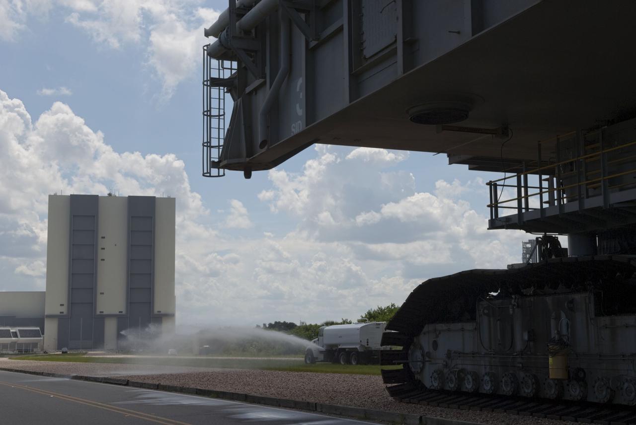 CAPE CANAVERAL, Fla. -- At NASA's Kennedy Space Center in Florida, Mobile Launcher Platform-3 (MLP), which supported space shuttle Atlantis for its final flight to the International Space Station on the STS-135 mission, is making its last journey from Launch Pad 39A back to the Vehicle Assembly Building (VAB) atop a massive crawler-transporter. A water truck leads the way spraying water on the dry crawlerway to reduce dust particles in the air.          For more than 40 years, the MLPs have traveled between the VAB to both launch pads at Launch Complex 39, and then returned to the VAB for future use. MLP-3 was first used to launch Columbia on the STS-32 mission on Jan. 9, 1990. Photo credit: NASA/Jim Grossmann
