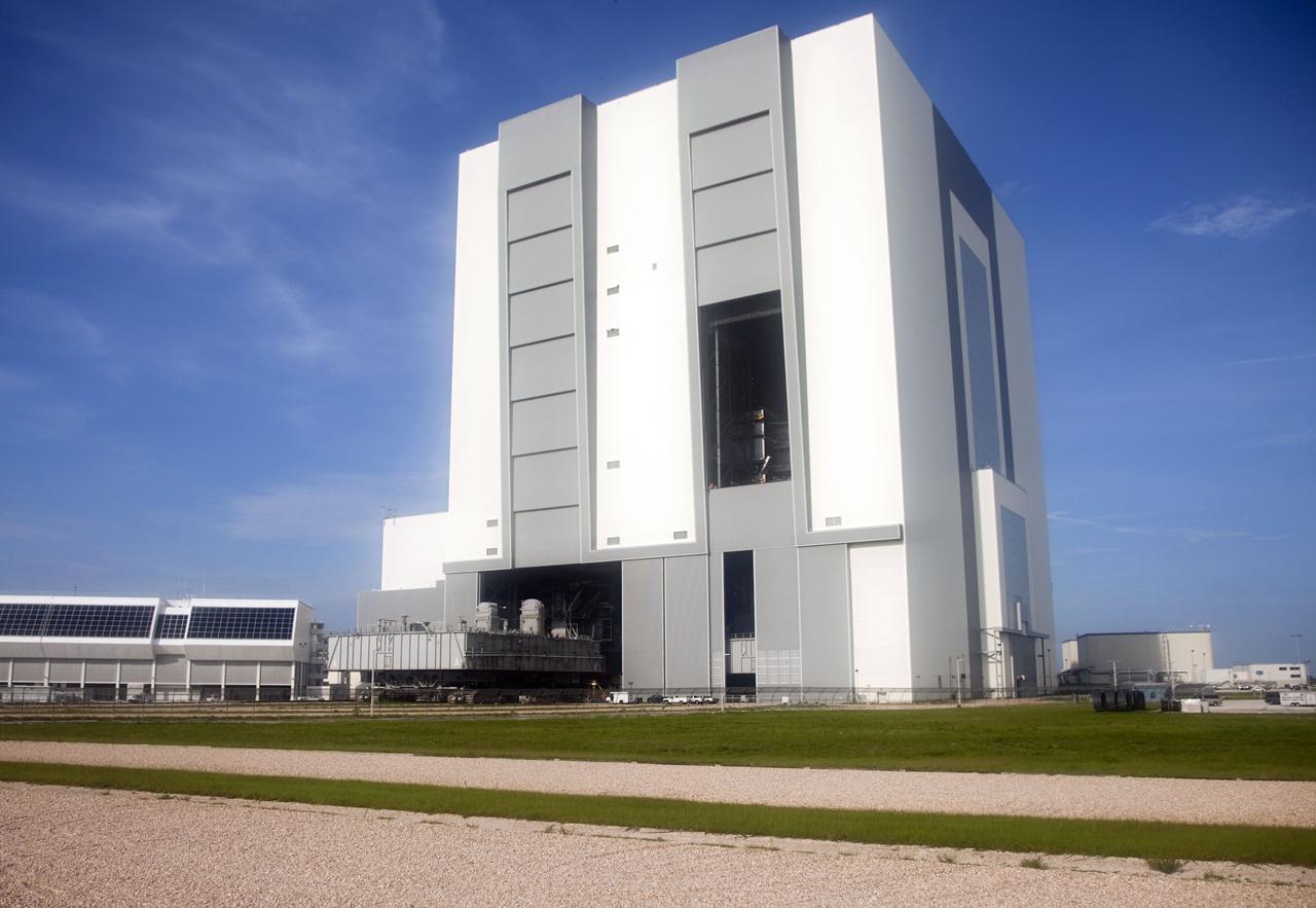 CAPE CANAVERAL, Fla. -- At NASA's Kennedy Space Center in Florida, Mobile Launcher Platform-3 (MLP), which supported space shuttle Atlantis for its final flight to the International Space Station on the STS-135 mission, has been delivered to the Vehicle Assembly Building (VAB) atop a crawler-transporter. Seen also is the Space Shuttle Program's Launch Control Center (left).          For more than 40 years, the MLPs have traveled between the massive VAB to both launch pads at Launch Complex 39, and then returned to the VAB for future use. MLP-3 was first used to launch Columbia on the STS-32 mission on Jan. 9, 1990. Photo credit: NASA/Frankie Martin