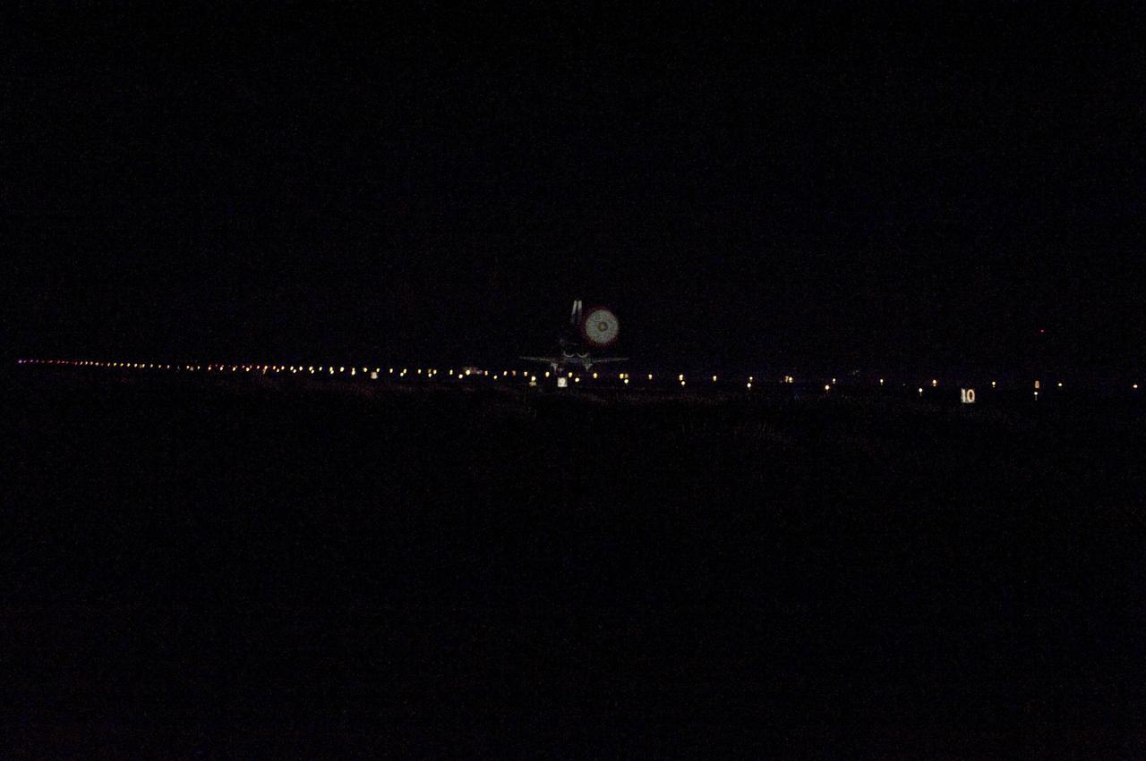 CAPE CANAVERAL, Fla. -- Space shuttle Atlantis' drag chute is illuminated as the spacecraft glides to a stop on Runway 15 at NASA's Kennedy Space Center in Florida for the last time. Securing the space shuttle fleet's place in history, Atlantis marked the 26th nighttime landing of NASA's Space Shuttle Program and the 78th landing at Kennedy. Main gear touchdown was at 5:57:00 a.m. EDT, followed by nose gear touchdown at 5:57:20 a.m., and wheelstop at 5:57:54 a.m. On board are STS-135 Commander Chris Ferguson, Pilot Doug Hurley, and Mission Specialists Sandra Magnus and Rex Walheim.        CAPE CANAVERAL, Fla. -- Xenons cast a halo of light on space shuttle Atlantis as the spacecraft approaches Runway 15 at NASA's Kennedy Space Center in Florida for the last time. Securing the space shuttle fleet's place in history, Atlantis marked the 26th nighttime landing of NASA's Space Shuttle Program and the 78th landing at Kennedy. Main gear touchdown was at 5:57:00 a.m. EDT, followed by nose gear touchdown at 5:57:20 a.m., and wheelstop at 5:57:54 a.m. On board are STS-135 Commander Chris Ferguson, Pilot Doug Hurley, and Mission Specialists Sandra Magnus and Rex Walheim.          On the 37th shuttle mission to the International Space Station, STS-135 delivered more than 9,400 pounds of spare parts, equipment and supplies in the Raffaello multi-purpose logistics module that will sustain station operations for the next year. STS-135 was the 33rd and final flight for Atlantis, which has spent 307 days in space, orbited Earth 4,848 times and traveled 125,935,769 miles. For more information visit, www.nasa.gov/mission_pages/shuttle/shuttlemissions/sts135/index.html. Photo credit: NASA/Carl Winebarger