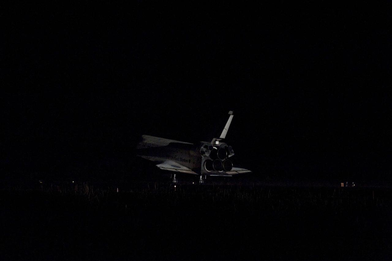 CAPE CANAVERAL, Fla. -- Space shuttle Atlantis' bright-white, iconic frame appears from the darkness at it touches down on the Shuttle Landing Facility's Runway 15 at NASA's Kennedy Space Center in Florida for the final time. Securing the space shuttle fleet's place in history, Atlantis marked the 26th nighttime landing of NASA's Space Shuttle Program and the 78th landing at Kennedy. Main gear touchdown was at 5:57:00 a.m. EDT, followed by nose gear touchdown at 5:57:20 a.m., and wheelstop at 5:57:54 a.m. On board are STS-135 Commander Chris Ferguson, Pilot Doug Hurley, and Mission Specialists Sandra Magnus and Rex Walheim.          On the 37th shuttle mission to the International Space Station, STS-135 delivered more than 9,400 pounds of spare parts, equipment and supplies in the Raffaello multi-purpose logistics module that will sustain station operations for the next year. STS-135 was the 33rd and final flight for Atlantis, which has spent 307 days in space, orbited Earth 4,848 times and traveled 125,935,769 miles. For more information visit, www.nasa.gov/mission_pages/shuttle/shuttlemissions/sts135/index.html. Photo credit: NASA/Linda Perry