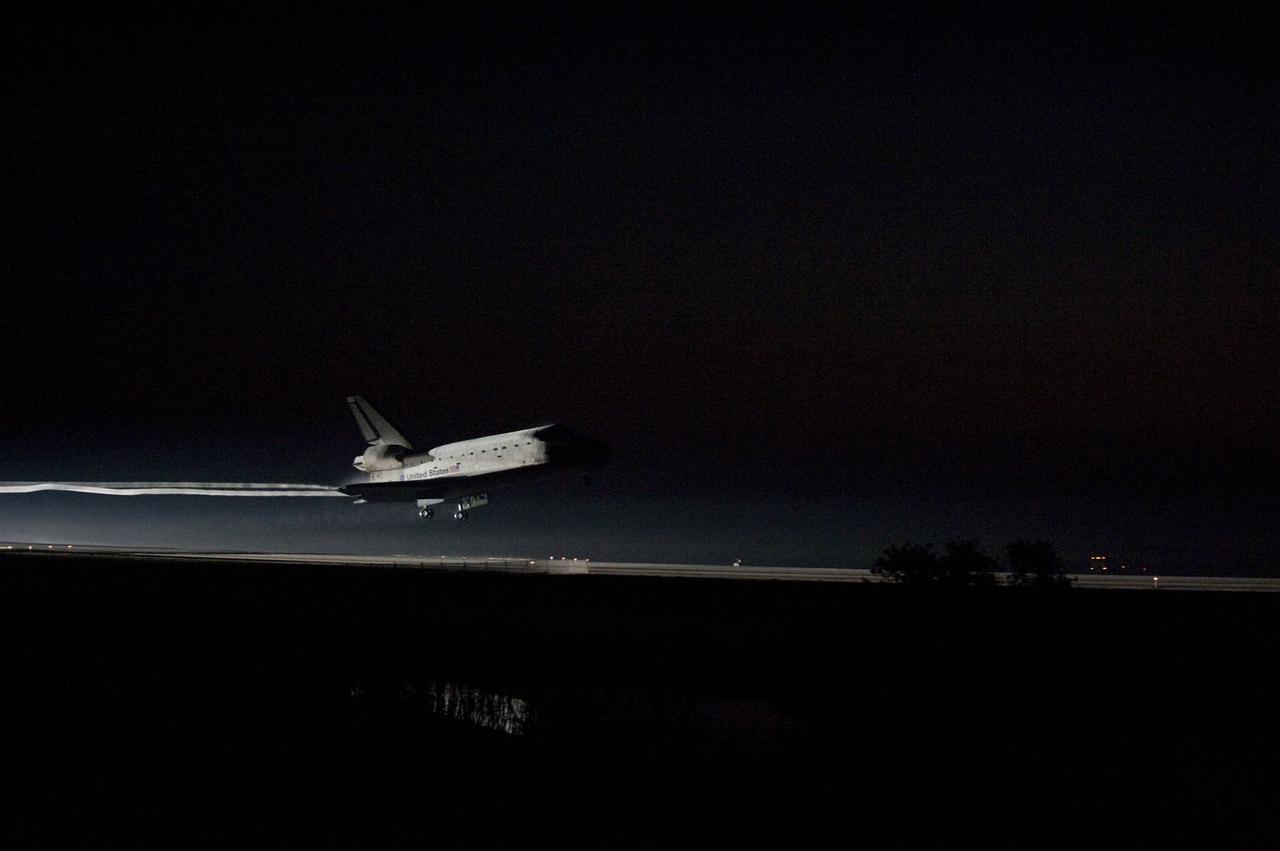 CAPE CANAVERAL, Fla. -- Xenons light the way home as space shuttle Atlantis' iconic white frame appears over the Shuttle Landing Facility's Runway 15 at NASA's Kennedy Space Center in Florida for the last time. Securing the space shuttle fleet's place in history, Atlantis marked the 26th nighttime landing of NASA's Space Shuttle Program and the 78th landing at Kennedy. Main gear touchdown was at 5:57:00 a.m. EDT, followed by nose gear touchdown at 5:57:20 a.m., and wheelstop at 5:57:54 a.m. On board are STS-135 Commander Chris Ferguson, Pilot Doug Hurley, and Mission Specialists Sandra Magnus and Rex Walheim.                On the 37th shuttle mission to the International Space Station, STS-135 delivered more than 9,400 pounds of spare parts, equipment and supplies in the Raffaello multi-purpose logistics module that will sustain station operations for the next year. STS-135 was the 33rd and final flight for Atlantis, which has spent 307 days in space, orbited Earth 4,848 times and traveled 125,935,769 miles. For more information visit, www.nasa.gov/mission_pages/shuttle/shuttlemissions/sts135/index.html. Photo credit: NASA/Sandra Joseph