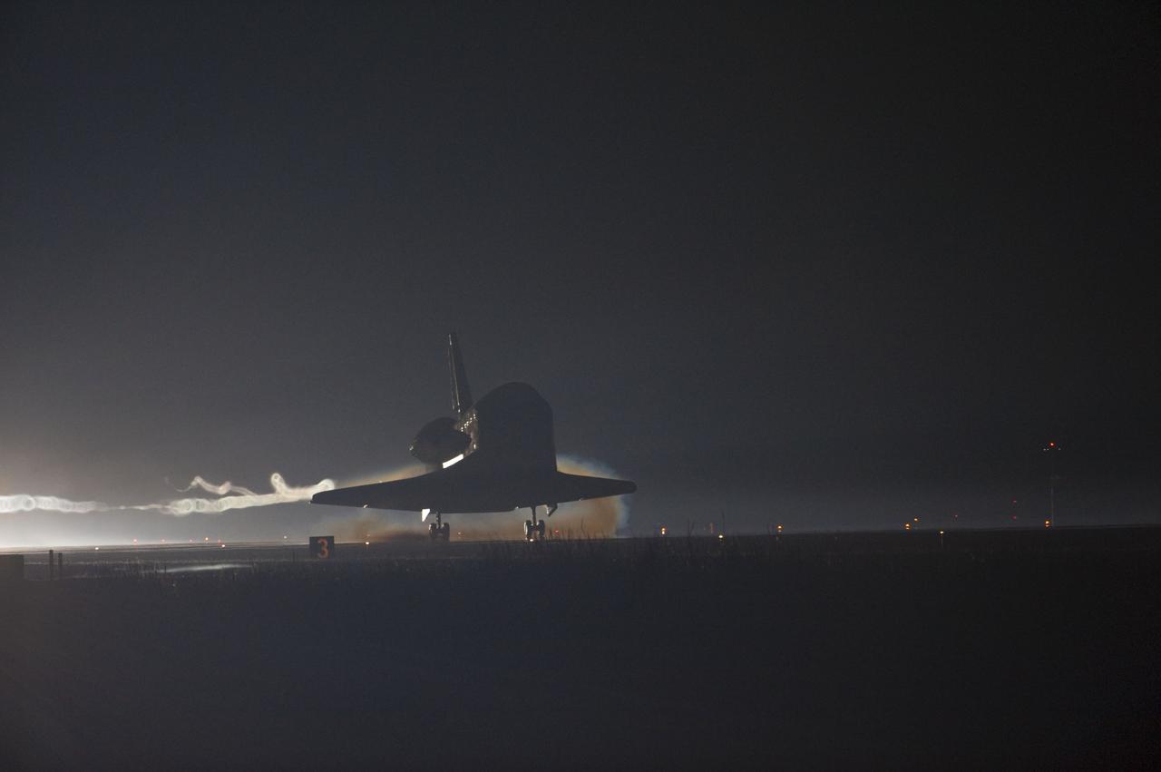 CAPE CANAVERAL, Fla. -- Ribbons of steam and smoke trail space shuttle Atlantis as it touches down on the Shuttle Landing Facility's Runway 15 at NASA's Kennedy Space Center in Florida for the final time. Securing the space shuttle fleet's place in history, Atlantis marked the 26th nighttime landing of NASA's Space Shuttle Program and the 78th landing at Kennedy. Main gear touchdown was at 5:57:00 a.m. EDT, followed by nose gear touchdown at 5:57:20 a.m., and wheelstop at 5:57:54 a.m. On board are STS-135 Commander Chris Ferguson, Pilot Doug Hurley, and Mission Specialists Sandra Magnus and Rex Walheim.      On the 37th shuttle mission to the International Space Station, STS-135 delivered more than 9,400 pounds of spare parts, equipment and supplies in the Raffaello multi-purpose logistics module that will sustain station operations for the next year. STS-135 was the 33rd and final flight for Atlantis, which has spent 307 days in space, orbited Earth 4,848 times and traveled 125,935,769 miles. For more information visit, www.nasa.gov/mission_pages/shuttle/shuttlemissions/sts135/index.html. Photo credit: NASA/Kevin O'Connell