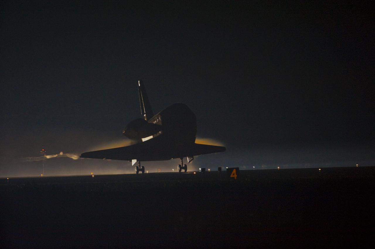 CAPE CANAVERAL, Fla. -- Ribbons of steam and smoke trail space shuttle Atlantis as it touches down on the Shuttle Landing Facility's Runway 15 at NASA's Kennedy Space Center in Florida for the final time. Securing the space shuttle fleet's place in history, Atlantis marked the 26th nighttime landing of NASA's Space Shuttle Program and the 78th landing at Kennedy. Main gear touchdown was at 5:57:00 a.m. EDT, followed by nose gear touchdown at 5:57:20 a.m., and wheelstop at 5:57:54 a.m. On board are STS-135 Commander Chris Ferguson, Pilot Doug Hurley, and Mission Specialists Sandra Magnus and Rex Walheim.      On the 37th shuttle mission to the International Space Station, STS-135 delivered more than 9,400 pounds of spare parts, equipment and supplies in the Raffaello multi-purpose logistics module that will sustain station operations for the next year. STS-135 was the 33rd and final flight for Atlantis, which has spent 307 days in space, orbited Earth 4,848 times and traveled 125,935,769 miles. For more information visit, www.nasa.gov/mission_pages/shuttle/shuttlemissions/sts135/index.html. Photo credit: NASA/Kevin O'Connell