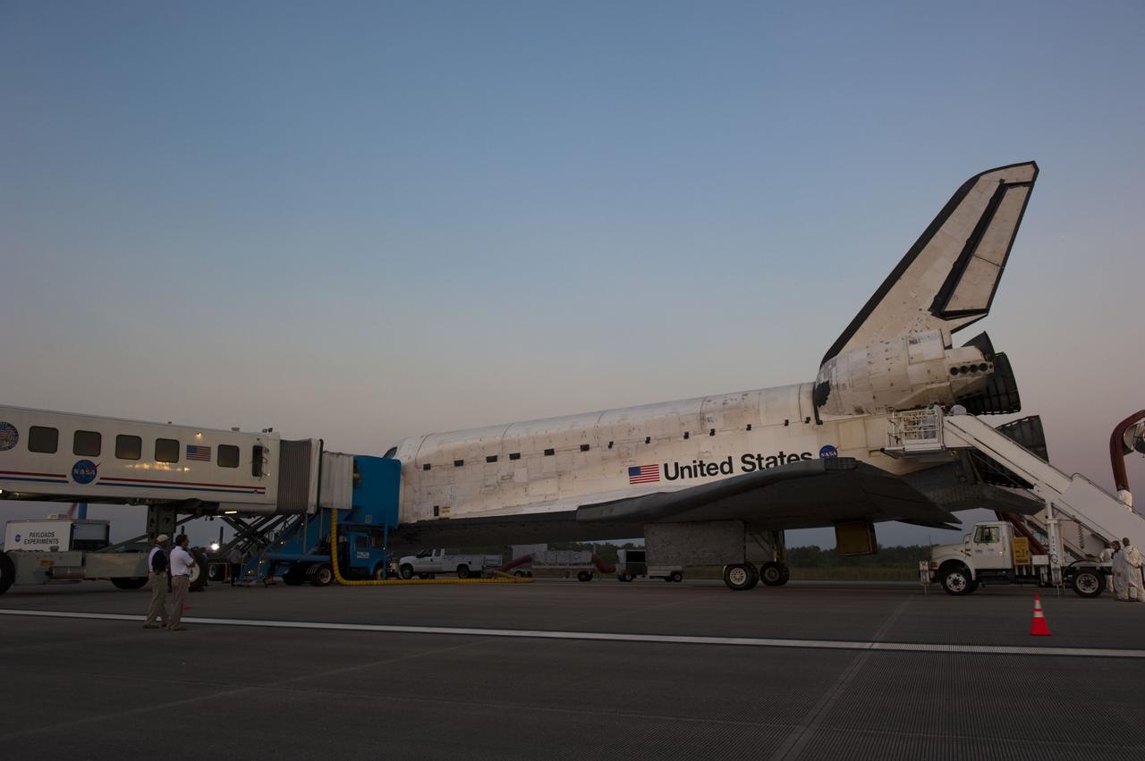 CAPE CANAVERAL, Fla. -- The landing convoy that will make space shuttle Atlantis safe and secure for towing to its processing hangar begins to pull up around the spacecraft following wheelstop on the Shuttle Landing Facility's Runway 15 at NASA's Kennedy Space Center in Florida. Atlantis' final return from space at 5:57 a.m. EDT completed the 13-day, 5.2-million-mile STS-135 mission. Securing the space shuttle fleet's place in history, Atlantis safely and successfully brought a close to NASA's Space Shuttle Program.            STS-135 delivered spare parts, equipment and supplies in the Raffaello multi-purpose logistics module that will sustain station operations for the next year. STS-135 was the 33rd and final flight for Atlantis, which has spent 307 days in space, orbited Earth 4,848 times and traveled 125,935,769 miles. For more information visit, www.nasa.gov/mission_pages/shuttle/shuttlemissions/sts135/index.html. Photo credit: NASA/Kim Shiflett