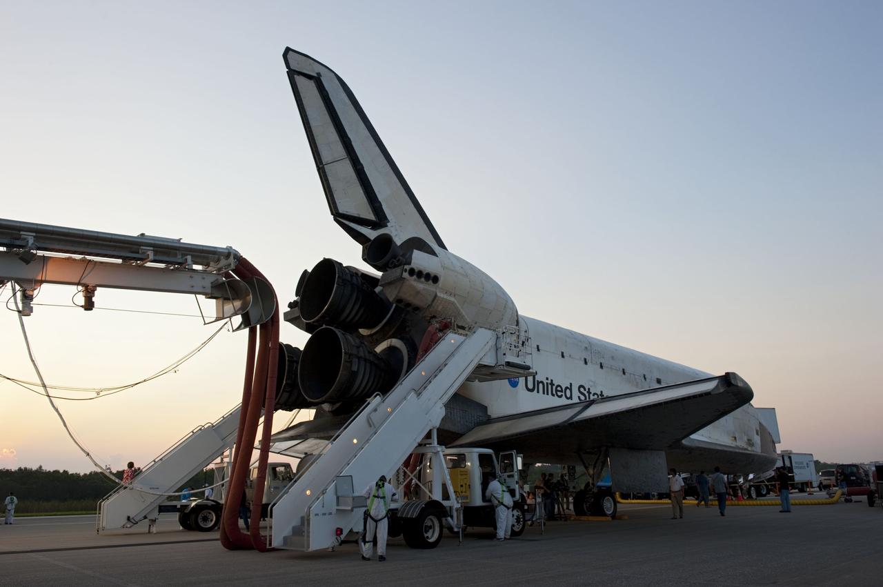 CAPE CANAVERAL, Fla. -- The landing convoy that will make space shuttle Atlantis safe and secure for towing to its processing hangar begins to pull up around the spacecraft following wheelstop on the Shuttle Landing Facility's Runway 15 at NASA's Kennedy Space Center in Florida. Atlantis' final return from space at 5:57 a.m. EDT completed the 13-day, 5.2-million-mile STS-135 mission. Securing the space shuttle fleet's place in history, Atlantis safely and successfully brought a close to NASA's Space Shuttle Program.            STS-135 delivered spare parts, equipment and supplies in the Raffaello multi-purpose logistics module that will sustain station operations for the next year. STS-135 was the 33rd and final flight for Atlantis, which has spent 307 days in space, orbited Earth 4,848 times and traveled 125,935,769 miles. For more information visit, www.nasa.gov/mission_pages/shuttle/shuttlemissions/sts135/index.html. Photo credit: NASA/Kim Shiflett