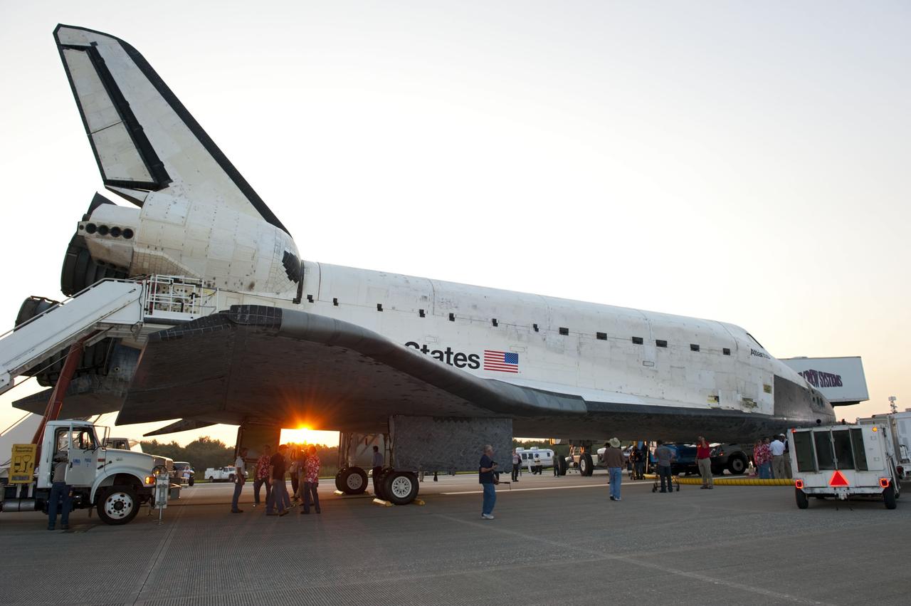 CAPE CANAVERAL, Fla. -- As the sun rises over Florida's Space Coast, the landing convoy crew that will make space shuttle Atlantis safe and secure for towing to its processing hangar begins to work on the spacecraft following wheelstop on the Shuttle Landing Facility's Runway 15 at NASA's Kennedy Space Center. Atlantis' final return from space at 5:57 a.m. EDT completed the 13-day, 5.2-million-mile STS-135 mission. Securing the space shuttle fleet's place in history, Atlantis safely and successfully brought a close to NASA's Space Shuttle Program.                   STS-135 delivered spare parts, equipment and supplies in the Raffaello multi-purpose logistics module that will sustain station operations for the next year. STS-135 was the 33rd and final flight for Atlantis, which has spent 307 days in space, orbited Earth 4,848 times and traveled 125,935,769 miles. For more information visit, www.nasa.gov/mission_pages/shuttle/shuttlemissions/sts135/index.html. Photo credit: NASA/Kim Shiflett