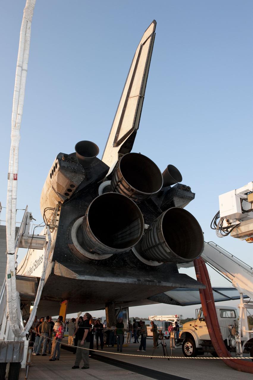 CAPE CANAVERAL, Fla. -- The landing convoy crew that will make space shuttle Atlantis safe and secure for towing to its processing hangar works on the spacecraft following wheelstop on the Shuttle Landing Facility's Runway 15 at NASA's Kennedy Space Center. Atlantis' final return from space at 5:57 a.m. EDT completed the 13-day, 5.2-million-mile STS-135 mission. Securing the space shuttle fleet's place in history, Atlantis brought a close to NASA's Space Shuttle Program.                    STS-135 delivered spare parts, equipment and supplies in the Raffaello multi-purpose logistics module that will sustain station operations for the next year. STS-135 was the 33rd and final flight for Atlantis, which has spent 307 days in space, orbited Earth 4,848 times and traveled 125,935,769 miles. For more information visit, www.nasa.gov/mission_pages/shuttle/shuttlemissions/sts135/index.html. Photo credit: NASA/Kim Shiflett