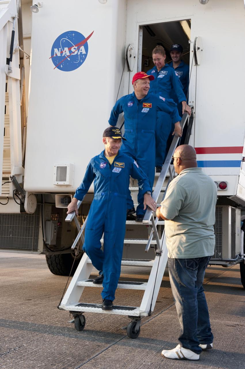 CAPE CANAVERAL, Fla. -- STS-135 Commander Chris Ferguson leads his crew out of the Crew Transport Vehicle (CTV) following brief and standard medical checks. Behind Ferguson are Pilot Doug Hurley, and Mission Specialists Sandy Magnus and Rex Walheim. The final four astronauts of NASA's Space Shuttle Program brought space shuttle Atlantis home to the Shuttle Landing Facility's Runway 15 at NASA's Kennedy Space Center in Florida at 5:57 a.m. EDT. Atlantis' final return from space completed a 13-day, 5.2-million-mile journey to the International Space Station.               STS-135 delivered spare parts, equipment and supplies in the Raffaello multi-purpose logistics module that will sustain station operations for the next year. STS-135 was the 33rd and final flight for Atlantis, which has spent 307 days in space, orbited Earth 4,848 times and traveled 125,935,769 miles. For more information visit, www.nasa.gov/mission_pages/shuttle/shuttlemissions/sts135/index.html. Photo credit: NASA/Kim Shiflett