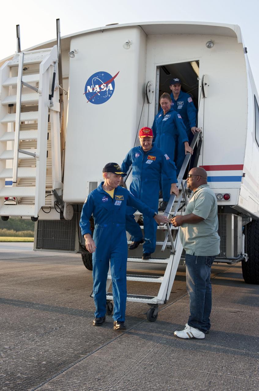 CAPE CANAVERAL, Fla. -- STS-135 Commander Chris Ferguson leads his crew out of the Crew Transport Vehicle (CTV) following brief and standard medical checks. Behind Ferguson are Pilot Doug Hurley, and Mission Specialists Sandy Magnus and Rex Walheim. The final four astronauts of NASA's Space Shuttle Program brought space shuttle Atlantis home to the Shuttle Landing Facility's Runway 15 at NASA's Kennedy Space Center in Florida at 5:57 a.m. EDT. Atlantis' final return from space completed a 13-day, 5.2-million-mile journey to the International Space Station.               STS-135 delivered spare parts, equipment and supplies in the Raffaello multi-purpose logistics module that will sustain station operations for the next year. STS-135 was the 33rd and final flight for Atlantis, which has spent 307 days in space, orbited Earth 4,848 times and traveled 125,935,769 miles. For more information visit, www.nasa.gov/mission_pages/shuttle/shuttlemissions/sts135/index.html. Photo credit: NASA/Kim Shiflett