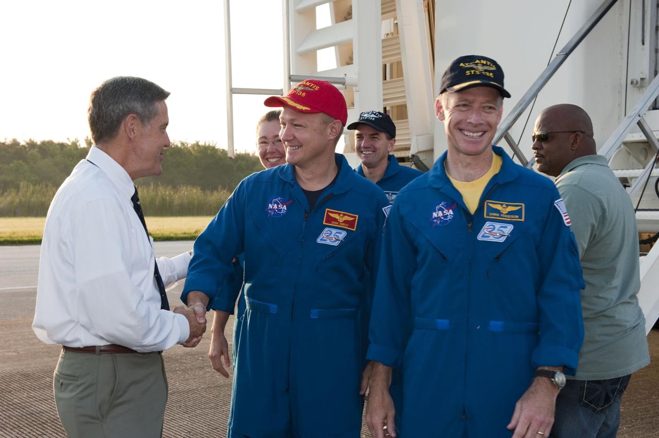 CAPE CANAVERAL, Fla. -- NASA Kennedy Space Center Director Bob Cabana, left, congratulates STS-135 Pilot Doug Hurley on the successful STS-135 mission to the International Space Station. Next to Hurley is Commander Chris Ferguson, and behind him are Mission Specialists Sandy Magnus, left, and Rex Walheim. The final four astronauts of NASA's Space Shuttle Program brought space shuttle Atlantis home to the Shuttle Landing Facility's Runway 15 at NASA's Kennedy Space Center in Florida at 5:57 a.m. EDT. Atlantis' final return from space completed a 13-day, 5.2-million-mile journey to the International Space Station.           STS-135 delivered spare parts, equipment and supplies in the Raffaello multi-purpose logistics module that will sustain station operations for the next year. STS-135 was the 33rd and final flight for Atlantis, which has spent 307 days in space, orbited Earth 4,848 times and traveled 125,935,769 miles. For more information visit, www.nasa.gov/mission_pages/shuttle/shuttlemissions/sts135/index.html. Photo credit: NASA/Kim Shiflett