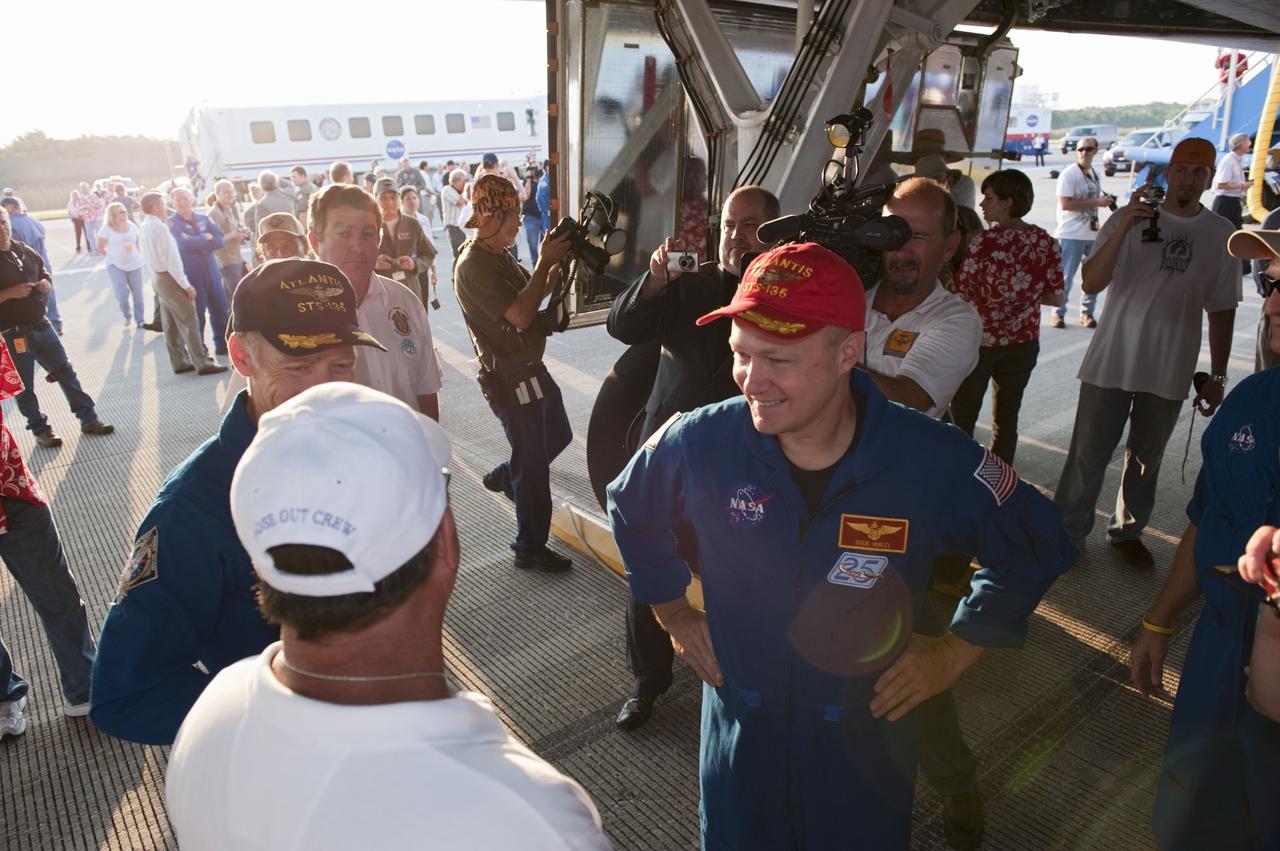 CAPE CANAVERAL, Fla. -- The STS-135 crew members are congratulated on their successful mission to the International Space Station. Four astronauts brought space shuttle Atlantis home to the Shuttle Landing Facility's Runway 15 at NASA's Kennedy Space Center in Florida at 5:57 a.m. EDT bringing a close NASA's Space Shuttle Program. Atlantis' final return from space completed a 13-day, 5.2-million-mile journey to the International Space Station.                    STS-135 delivered spare parts, equipment and supplies in the Raffaello multi-purpose logistics module that will sustain station operations for the next year. STS-135 was the 33rd and final flight for Atlantis, which has spent 307 days in space, orbited Earth 4,848 times and traveled 125,935,769 miles. For more information visit, www.nasa.gov/mission_pages/shuttle/shuttlemissions/sts135/index.html. Photo credit: NASA/Kim Shiflett