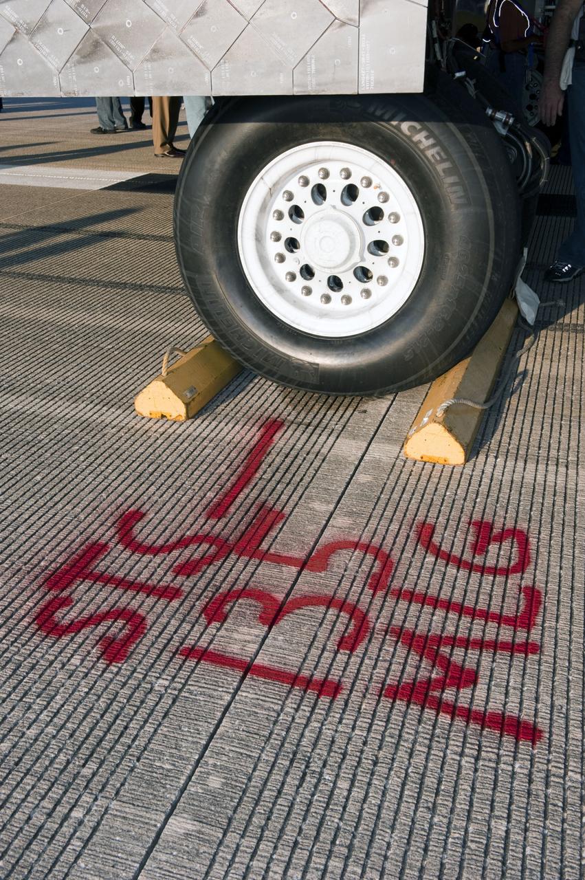 CAPE CANAVERAL, Fla. -- Workers measured and marked in bright red the letters "MLG" at the spot where space shuttle Atlantis' main landing gear came to a stop after the vehicle's final return from space. Securing the space shuttle fleet's place in history on the STS-135 mission, Atlantis safely and successfully rounded out NASA's Space Shuttle Program on the Shuttle Landing Facility's Runway 15 at Kennedy Space Center in Florida. Main gear touchdown was at 5:57:00 a.m. EDT, followed by nose gear touchdown at 5:57:20 a.m., and wheelstop at 5:57:54 a.m.       On the 37th shuttle mission to the International Space Station, STS-135 delivered more than 9,400 pounds of spare parts, equipment and supplies in the Raffaello multi-purpose logistics module that will sustain station operations for the next year. STS-135 was the 33rd and final flight for Atlantis, which has spent 307 days in space, orbited Earth 4,848 times and traveled 125,935,769 miles. For more information visit, www.nasa.gov/mission_pages/shuttle/shuttlemissions/sts135/index.html. Photo credit: NASA/Kim Shiflett