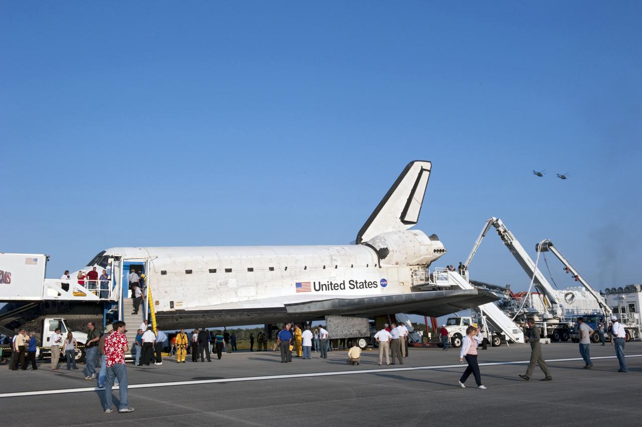 CAPE CANAVERAL, Fla. -- Employees admire space shuttle Atlantis as the landing convoy crew makes the vehicle safe for towing to its processing hangar at NASA's Kennedy Space Center in Florida. Atlantis' final return to Earth on the Shuttle Landing Facility's Runway 15 at NASA's Kennedy Space Center in Florida occurred at 5:57 a.m. EDT. Completing the 13-day, 5.2-million-mile STS-135 mission, Atlantis secured the space shuttle fleet's place in history and brought a close to NASA's Space Shuttle Program.              STS-135 delivered spare parts, equipment and supplies in the Raffaello multi-purpose logistics module that will sustain station operations for the next year. STS-135 was the 33rd and final flight for Atlantis, which has spent 307 days in space, orbited Earth 4,848 times and traveled 125,935,769 miles. For more information visit, www.nasa.gov/mission_pages/shuttle/shuttlemissions/sts135/index.html. Photo credit: NASA/Kim Shiflett