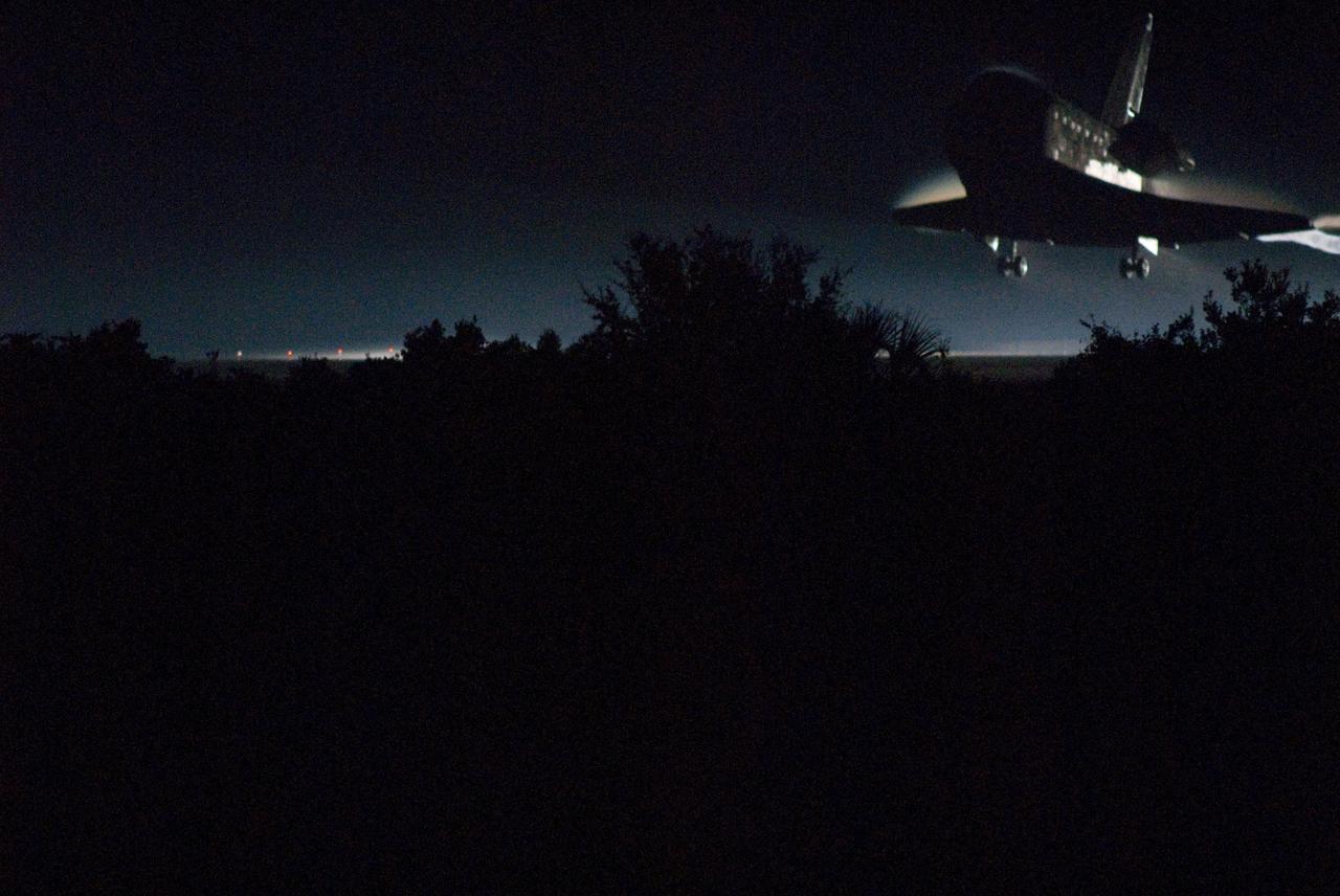 CAPE CANAVERAL, Fla. -- In darkness, space shuttle Atlantis nears touchdown for the final time on Runway 15 at the Shuttle Landing Facility at NASA's Kennedy Space Center in Florida. Securing the space shuttle fleet's place in history, Atlantis marked the 26th nighttime landing of NASA's Space Shuttle Program and the 78th landing at Kennedy. Main gear touchdown was at 5:57:00 a.m. EDT, followed by nose gear touchdown at 5:57:20 a.m., and wheelstop at 5:57:54 a.m. On board are STS-135 Commander Chris Ferguson, Pilot Doug Hurley, and Mission Specialists Sandra Magnus and Rex Walheim.    On the 37th shuttle mission to the International Space Station, STS-135 delivered in the Raffaello multi-purpose logistics module    more than 9,400 pounds of spare parts, equipment and supplies that will sustain station operations for the next year. STS-135 was the 33rd and final flight for Atlantis, which has spent 307 days in space, orbited Earth 4,848 times and traveled 125,935,769 miles. STS-135 is the final mission in the Space Shuttle Program. For more information, visit www.nasa.gov/mission_pages/shuttle/shuttlemissions/sts135/index.html. Photo credit: NASA/Rick Wetherington