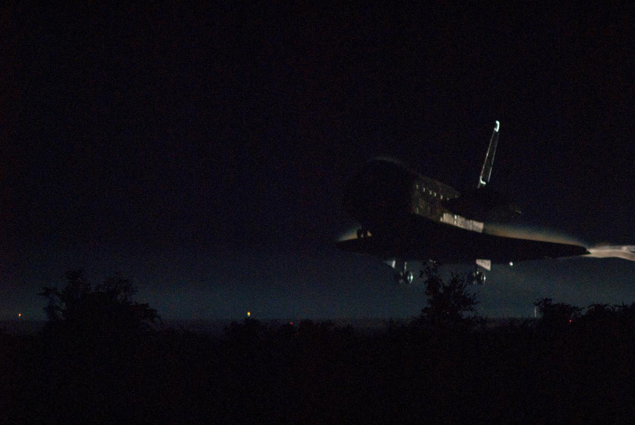 CAPE CANAVERAL, Fla. -- Enshrouded in darkness, space shuttle Atlantis nears touchdown for the final time on Runway 15 at the Shuttle Landing Facility at NASA's Kennedy Space Center in Florida. Securing the space shuttle fleet's place in history, Atlantis marked the 26th nighttime landing of NASA's Space Shuttle Program and the 78th landing at Kennedy. Main gear touchdown was at 5:57:00 a.m. EDT, followed by nose gear touchdown at 5:57:20 a.m., and wheelstop at 5:57:54 a.m. On board are STS-135 Commander Chris Ferguson, Pilot Doug Hurley, and Mission Specialists Sandra Magnus and Rex Walheim.    On the 37th shuttle mission to the International Space Station, STS-135 delivered in the Raffaello multi-purpose logistics module    more than 9,400 pounds of spare parts, equipment and supplies that will sustain station operations for the next year. STS-135 was the 33rd and final flight for Atlantis, which has spent 307 days in space, orbited Earth 4,848 times and traveled 125,935,769 miles. STS-135 is the final mission in the Space Shuttle Program. For more information, visit www.nasa.gov/mission_pages/shuttle/shuttlemissions/sts135/index.html. Photo credit: NASA/Rick Wetherington