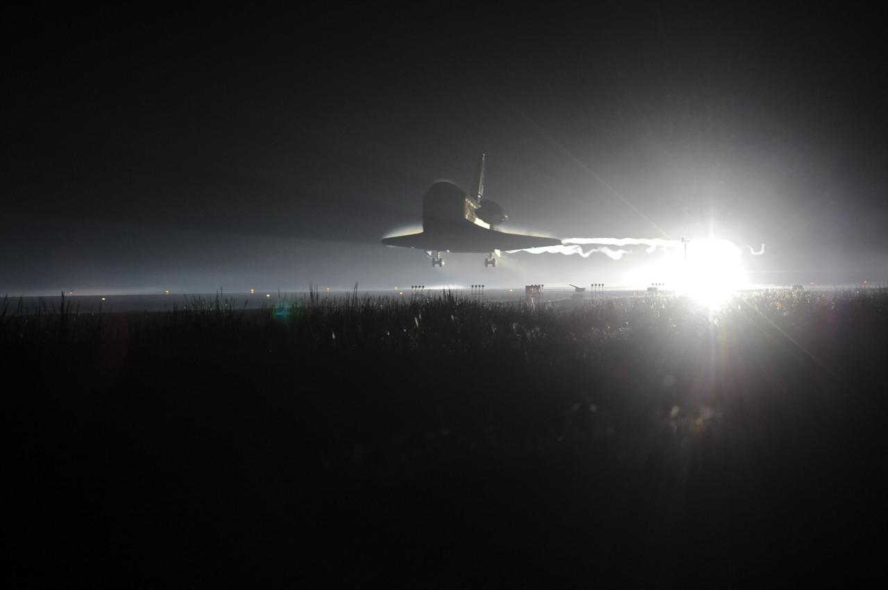 CAPE CANAVERAL, Fla. -- Ribbons of steam and smoke trail space shuttle Atlantis as it touches down for the final time on the Shuttle Landing Facility's Runway 15 at NASA's Kennedy Space Center in Florida. Securing the space shuttle fleet's place in history, Atlantis marked the 26th nighttime landing of NASA's Space Shuttle Program and the 78th landing at Kennedy. Main gear touchdown was at 5:57:00 a.m. EDT, followed by nose gear touchdown at 5:57:20 a.m., and wheelstop at 5:57:54 a.m. On board are STS-135 Commander Chris Ferguson, Pilot Doug Hurley, and Mission Specialists Sandra Magnus and Rex Walheim.    On the 37th shuttle mission to the International Space Station, STS-135 delivered in the Raffaello multi-purpose logistics module    more than 9,400 pounds of spare parts, equipment and supplies that will sustain station operations for the next year. STS-135 was the 33rd and final flight for Atlantis, which has spent 307 days in space, orbited Earth 4,848 times and traveled 125,935,769 miles. STS-135 is the final mission in the Space Shuttle Program.  For more information, visit www.nasa.gov/mission_pages/shuttle/shuttlemissions/sts135/index.html. Photo credit: NASA/Chuck Tintera