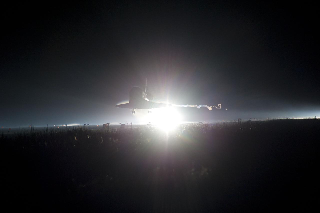 CAPE CANAVERAL, Fla. -- Backlit by the xenon lights on Runway 15 at the Shuttle Landing Facility, space shuttle Atlantis nears touchdown for the final time at NASA's Kennedy Space Center in Florida.  Securing the space shuttle fleet's place in history, Atlantis marked the 26th nighttime landing of NASA's Space Shuttle Program and the 78th landing at Kennedy. Main gear touchdown was at 5:57:00 a.m. EDT, followed by nose gear touchdown at 5:57:20 a.m., and wheelstop at 5:57:54 a.m. On board are STS-135 Commander Chris Ferguson, Pilot Doug Hurley, and Mission Specialists Sandra Magnus and Rex Walheim.    On the 37th shuttle mission to the International Space Station, STS-135 delivered the Raffaello multi-purpose logistics module    filled with more than 9,400 pounds of spare parts, equipment and supplies that will sustain station operations for the next year. STS-135 was the 33rd and final flight for Atlantis, which has spent 307 days in space, orbited Earth 4,848 times and traveled 125,935,769 miles. STS-135 also was the final mission of the Space Shuttle Program.  For more information, visit www.nasa.gov/mission_pages/shuttle/shuttlemissions/sts135/index.html. Photo credit: NASA/Chad Baumer