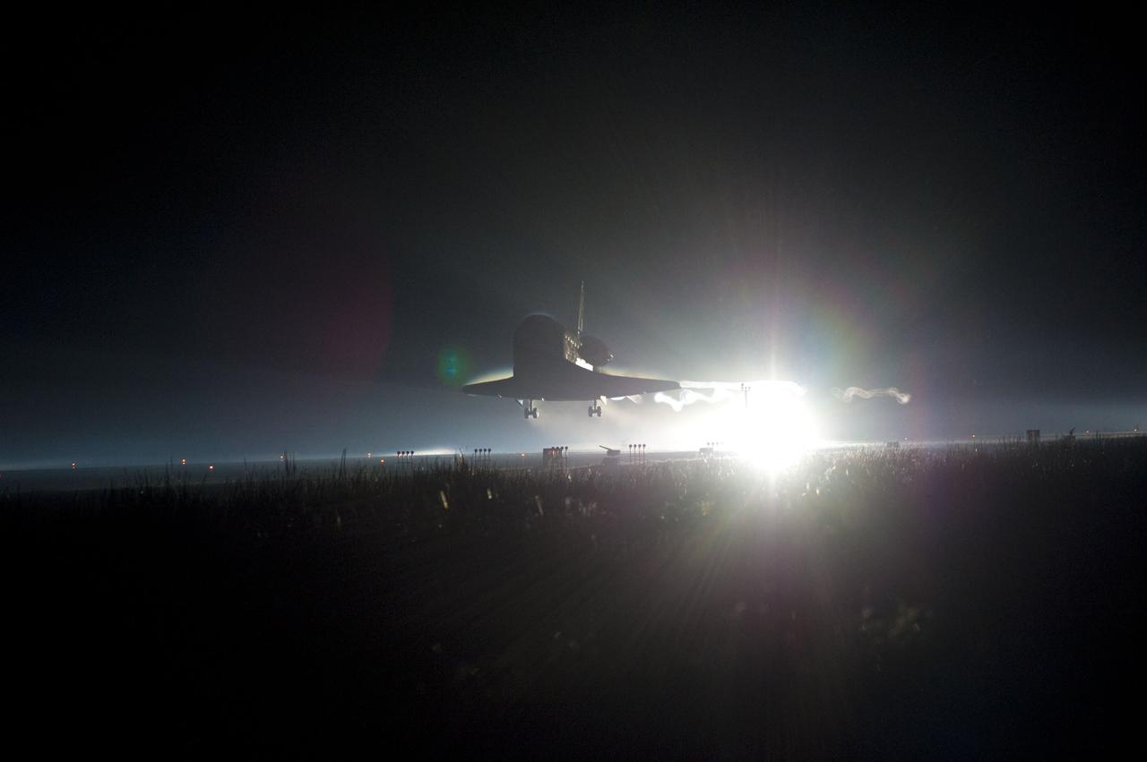 CAPE CANAVERAL, Fla. -- Backlit by the xenon lights on Runway 15 at the Shuttle Landing Facility, space shuttle Atlantis nears touchdown for the final time at NASA's Kennedy Space Center in Florida.  Securing the space shuttle fleet's place in history, Atlantis marked the 26th nighttime landing of NASA's Space Shuttle Program and the 78th landing at Kennedy. Main gear touchdown was at 5:57:00 a.m. EDT, followed by nose gear touchdown at 5:57:20 a.m., and wheelstop at 5:57:54 a.m. On board are STS-135 Commander Chris Ferguson, Pilot Doug Hurley, and Mission Specialists Sandra Magnus and Rex Walheim.    On the 37th shuttle mission to the International Space Station, STS-135 delivered the Raffaello multi-purpose logistics module    filled with more than 9,400 pounds of spare parts, equipment and supplies that will sustain station operations for the next year. STS-135 was the 33rd and final flight for Atlantis, which has spent 307 days in space, orbited Earth 4,848 times and traveled 125,935,769 miles. STS-135 also was the final mission of the Space Shuttle Program.  For more information, visit www.nasa.gov/mission_pages/shuttle/shuttlemissions/sts135/index.html. Photo credit: NASA/Chad Baumer