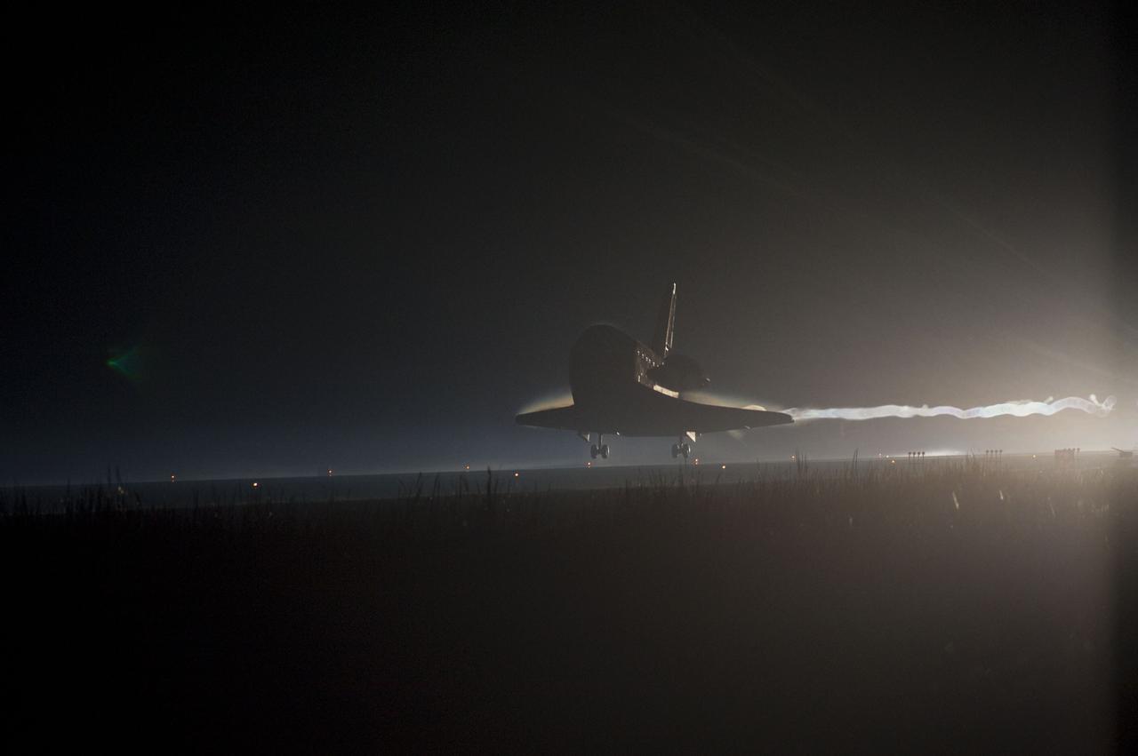 CAPE CANAVERAL, Fla. -- Xenon lights positioned on Runway 15 at the Shuttle Landing Facility reveal space shuttle Atlantis as it nears touchdown for the final time at NASA's Kennedy Space Center in Florida. Securing the space shuttle fleet's place in history, Atlantis marked the 26th nighttime landing of NASA's Space Shuttle Program and the 78th landing at Kennedy. Main gear touchdown was at 5:57:00 a.m. EDT, followed by nose gear touchdown at 5:57:20 a.m., and wheelstop at 5:57:54 a.m. On board are STS-135 Commander Chris Ferguson, Pilot Doug Hurley, and Mission Specialists Sandra Magnus and Rex Walheim.    On the 37th shuttle mission to the International Space Station, STS-135 delivered the Raffaello multi-purpose logistics module    filled with more than 9,400 pounds of spare parts, equipment and supplies that will sustain station operations for the next year. STS-135 was the 33rd and final flight for Atlantis, which has spent 307 days in space, orbited Earth 4,848 times and traveled 125,935,769 miles. STS-135 also was the final mission of the Space Shuttle Program.  For more information, visit www.nasa.gov/mission_pages/shuttle/shuttlemissions/sts135/index.html. Photo credit: NASA/Chad Baumer