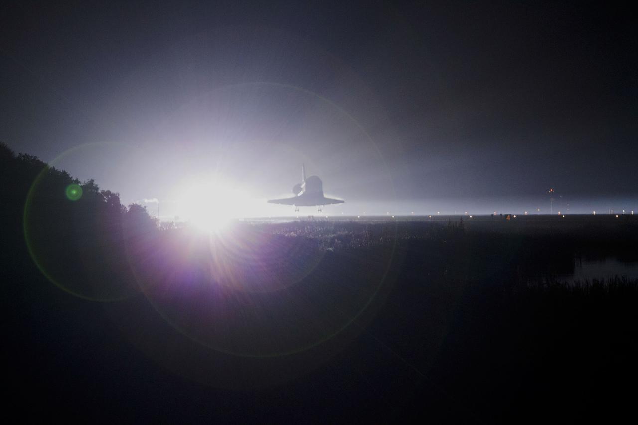 CAPE CANAVERAL, Fla. -- Xenons cast a halo of light on space shuttle Atlantis as the spacecraft nears touchdown for the last time on Runway 15 at NASA's Kennedy Space Center in Florida. Securing the space shuttle fleet's place in history, Atlantis marked the 26th nighttime landing of NASA's Space Shuttle Program and the 78th landing at Kennedy. Main gear touchdown was at 5:57:00 a.m. EDT, followed by nose gear touchdown at 5:57:20 a.m., and wheelstop at 5:57:54 a.m. On board are STS-135 Commander Chris Ferguson, Pilot Doug Hurley, and Mission Specialists Sandra Magnus and Rex Walheim.    On the 37th shuttle mission to the International Space Station, STS-135 delivered the Raffaello multi-purpose logistics module filled with more than 9,400 pounds of spare parts, equipment and supplies that will sustain station operations for the next year. STS-135 was the 33rd and final flight for Atlantis, which has spent 307 days in space, orbited Earth 4,848 times and traveled 125,935,769 miles. STS-135 also was the final mission of the Space Shuttle Program.  For more information, visit www.nasa.gov/mission_pages/shuttle/shuttlemissions/sts135/index.html. Photo credit: NASA/Kenny Allen