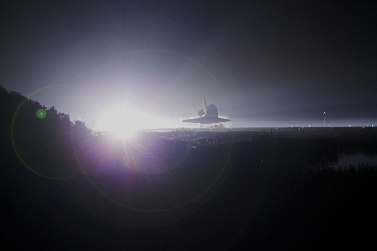 CAPE CANAVERAL, Fla. -- A halo of light engulfs space shuttle Atlantis as the spacecraft nears touchdown for the last time on Runway 15 at NASA's Kennedy Space Center in Florida. Securing the space shuttle fleet's place in history, Atlantis marked the 26th nighttime landing of NASA's Space Shuttle Program and the 78th landing at Kennedy. Main gear touchdown was at 5:57:00 a.m. EDT, followed by nose gear touchdown at 5:57:20 a.m., and wheelstop at 5:57:54 a.m. On board are STS-135 Commander Chris Ferguson, Pilot Doug Hurley, and Mission Specialists Sandra Magnus and Rex Walheim.    On the 37th shuttle mission to the International Space Station, STS-135 delivered the Raffaello multi-purpose logistics module filled with more than 9,400 pounds of spare parts, equipment and supplies that will sustain station operations for the next year. STS-135 was the 33rd and final flight for Atlantis, which has spent 307 days in space, orbited Earth 4,848 times and traveled 125,935,769 miles. STS-135 also was the final mission of the Space Shuttle Program.  For more information, visit www.nasa.gov/mission_pages/shuttle/shuttlemissions/sts135/index.html. Photo credit: NASA/Kenny Allen