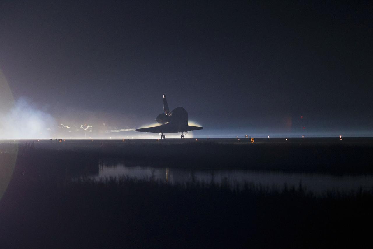 CAPE CANAVERAL, Fla. -- Backlit by the xenon lights on Runway 15 at the Shuttle Landing Facility, space shuttle Atlantis nears touchdown for the final time at NASA's Kennedy Space Center in Florida.  Securing the space shuttle fleet's place in history, Atlantis marked the 26th nighttime landing of NASA's Space Shuttle Program and the 78th landing at Kennedy. Main gear touchdown was at 5:57:00 a.m. EDT, followed by nose gear touchdown at 5:57:20 a.m., and wheelstop at 5:57:54 a.m. On board are STS-135 Commander Chris Ferguson, Pilot Doug Hurley, and Mission Specialists Sandra Magnus and Rex Walheim.    On the 37th shuttle mission to the International Space Station, STS-135 delivered the Raffaello multi-purpose logistics module filled with more than 9,400 pounds of spare parts, equipment and supplies that will sustain station operations for the next year. STS-135 was the 33rd and final flight for Atlantis, which has spent 307 days in space, orbited Earth 4,848 times and traveled 125,935,769 miles. STS-135 also was the final mission of the Space Shuttle Program.  For more information, visit www.nasa.gov/mission_pages/shuttle/shuttlemissions/sts135/index.html. Photo credit: NASA/Kenny Allen