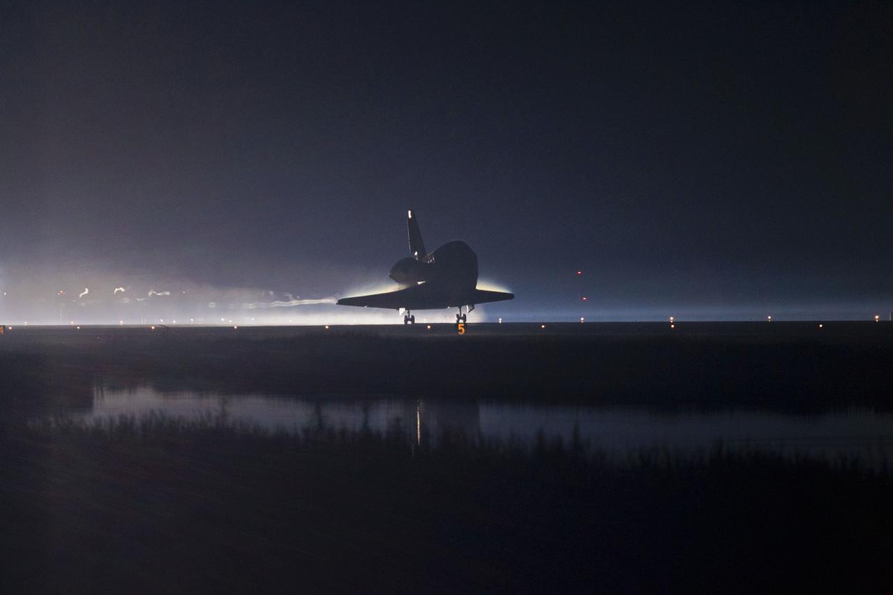 CAPE CANAVERAL, Fla. -- Trailing ribbons of steam and smoke, space shuttle Atlantis touches down for the final time on the Shuttle Landing Facility's Runway 15 at NASA's Kennedy Space Center in Florida. Securing the space shuttle fleet's place in history, Atlantis marked the 26th nighttime landing of NASA's Space Shuttle Program and the 78th landing at Kennedy. Main gear touchdown was at 5:57:00 a.m. EDT, followed by nose gear touchdown at 5:57:20 a.m., and wheelstop at 5:57:54 a.m. On board are STS-135 Commander Chris Ferguson, Pilot Doug Hurley, and Mission Specialists Sandra Magnus and Rex Walheim.    On the 37th shuttle mission to the International Space Station, STS-135 delivered the Raffaello multi-purpose logistics module filled with more than 9,400 pounds of spare parts, equipment and supplies that will sustain station operations for the next year. STS-135 was the 33rd and final flight for Atlantis, which has spent 307 days in space, orbited Earth 4,848 times and traveled 125,935,769 miles. STS-135 also was the final mission of the Space Shuttle Program.  For more information, visit www.nasa.gov/mission_pages/shuttle/shuttlemissions/sts135/index.html. Photo credit: NASA/Kenny Allen