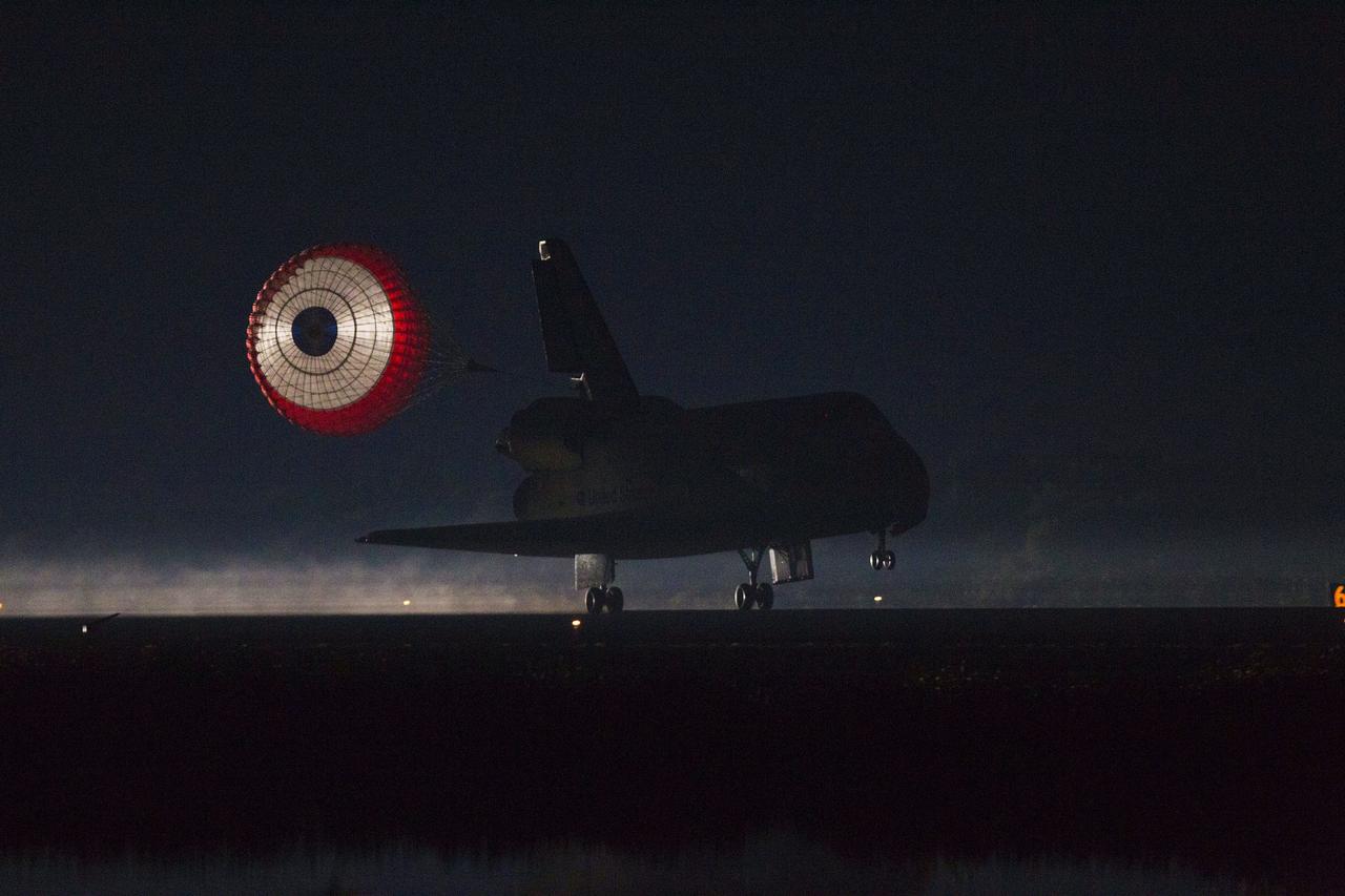 CAPE CANAVERAL, Fla. -- At the Shuttle Landing Facility at NASA's Kennedy Space Center in Florida, the drag chute trailing space shuttle Atlantis is illuminated by the xenon lights on Runway 15 as the shuttle lands for the final time. Securing the space shuttle fleet's place in history, Atlantis marked the 26th nighttime landing of NASA's Space Shuttle Program and the 78th landing at Kennedy. Main gear touchdown was at 5:57:00 a.m. EDT, followed by nose gear touchdown at 5:57:20 a.m., and wheelstop at 5:57:54 a.m. On board are STS-135 Commander Chris Ferguson, Pilot Doug Hurley, and Mission Specialists Sandra Magnus and Rex Walheim.    On the 37th shuttle mission to the International Space Station, STS-135 delivered the Raffaello multi-purpose logistics module filled with more than 9,400 pounds of spare parts, equipment and supplies that will sustain station operations for the next year. STS-135 was the 33rd and final flight for Atlantis, which has spent 307 days in space, orbited Earth 4,848 times and traveled 125,935,769 miles. STS-135 also was the final mission of the Space Shuttle Program.  For more information, visit www.nasa.gov/mission_pages/shuttle/shuttlemissions/sts135/index.html. Photo credit: NASA/Kenny Allen