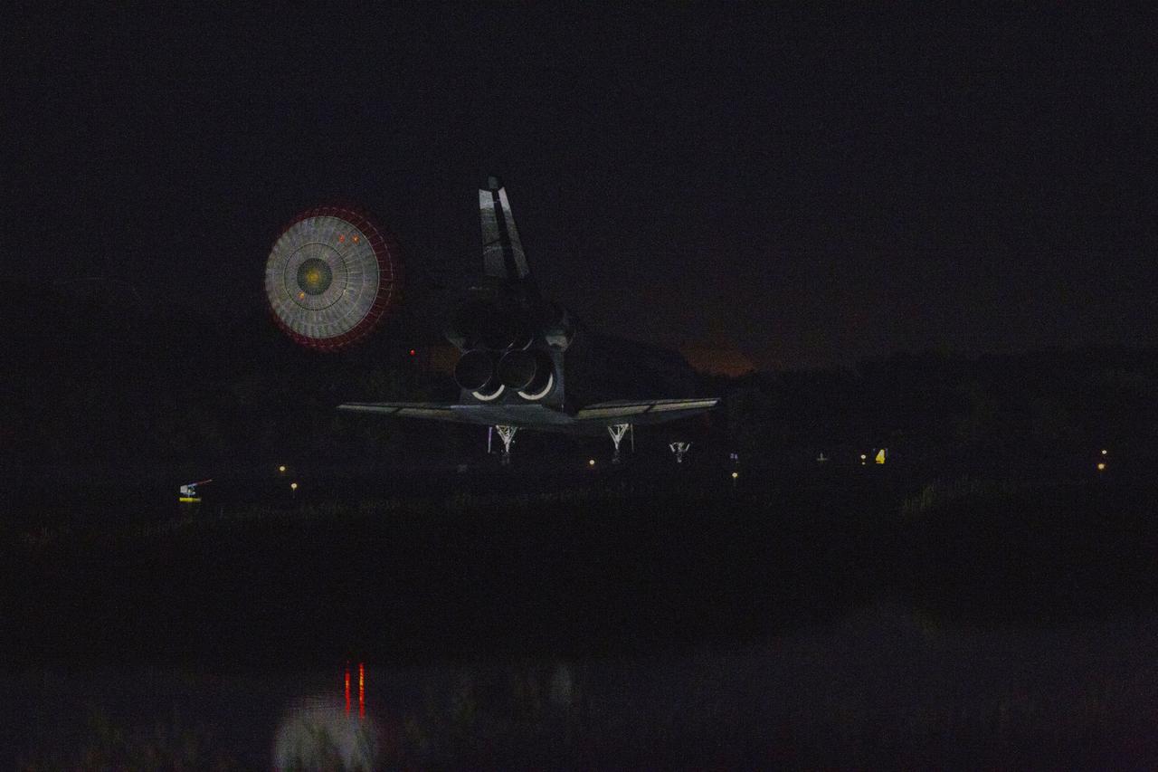 CAPE CANAVERAL, Fla. -- At the Shuttle Landing Facility at NASA's Kennedy Space Center in Florida, the drag chute trailing space shuttle Atlantis slows the near-invisible shuttle for landing on Runway 15 one final time.  Securing the space shuttle fleet's place in history, Atlantis marked the 26th nighttime landing of NASA's Space Shuttle Program and the 78th landing at Kennedy. Main gear touchdown was at 5:57:00 a.m. EDT, followed by nose gear touchdown at 5:57:20 a.m., and wheelstop at 5:57:54 a.m. On board are STS-135 Commander Chris Ferguson, Pilot Doug Hurley, and Mission Specialists Sandra Magnus and Rex Walheim.    On the 37th shuttle mission to the International Space Station, STS-135 delivered the Raffaello multi-purpose logistics module filled with more than 9,400 pounds of spare parts, equipment and supplies that will sustain station operations for the next year. STS-135 was the 33rd and final flight for Atlantis, which has spent 307 days in space, orbited Earth 4,848 times and traveled 125,935,769 miles. STS-135 also was the final mission of the Space Shuttle Program.  For more information, visit www.nasa.gov/mission_pages/shuttle/shuttlemissions/sts135/index.html. Photo credit: NASA/Kenny Allen