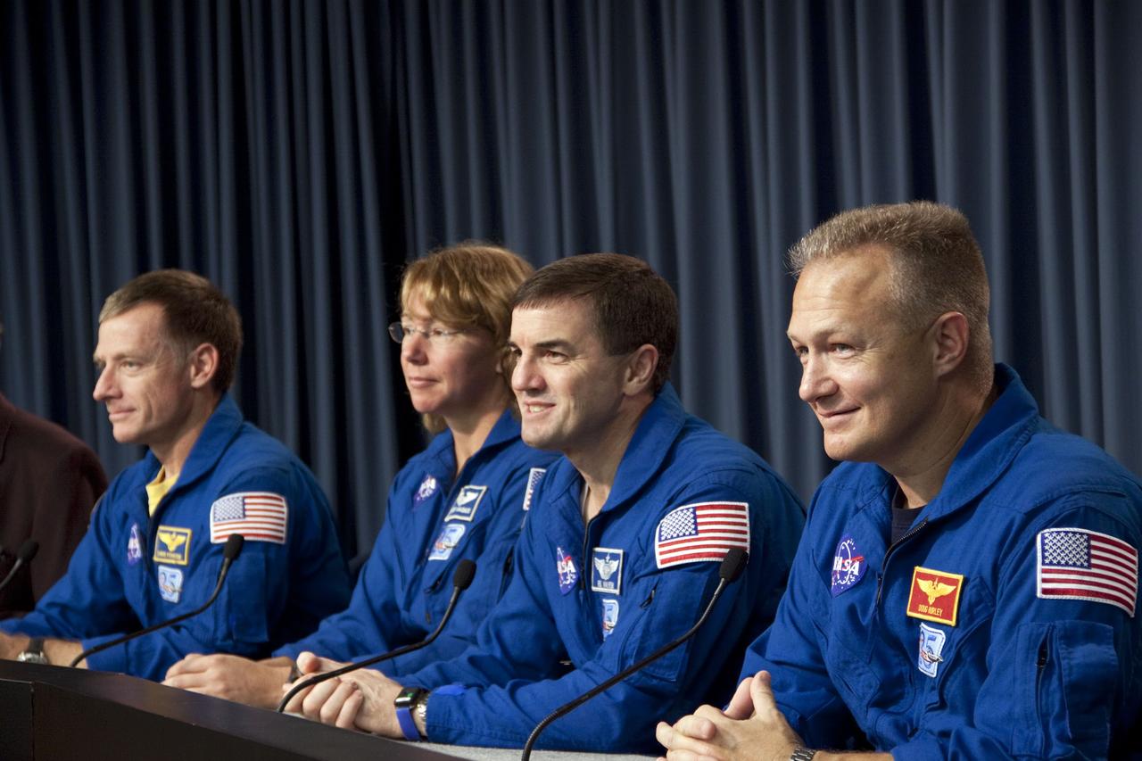 CAPE CANAVERAL, Fla. -- The crew of space shuttle Atlantis' STS-135 and final Space Shuttle Program Flight, participates in a news conference in the Press Site auditorium at NASA's Kennedy Space Center in Florida on landing day. Seen here are STS-135 Commander Chris Ferguson (left), Mission Specialists Sandy Magnus and Rex Walheim and Pilot Doug Hurley.  Securing the space shuttle fleet's place in history, Atlantis marked the 26th nighttime landing of NASA's Space Shuttle Program and the 78th landing at Kennedy. Main gear touchdown was at 5:57:00 a.m. EDT, followed by nose gear touchdown at 5:57:20 a.m., and wheelstop at 5:57:54 a.m. Atlantis and its crew delivered to the International Space Station the Raffaello multi-purpose logistics module packed with  more than 9,400 pounds of spare parts, equipment and supplies that will sustain station operations for the next year. STS-135 was the 33rd and final flight for Atlantis, which has spent 307 days in space, orbited Earth 4,848 times and traveled 125,935,769 miles. For more information, visit www.nasa.gov/mission_pages/shuttle/shuttlemissions/sts135/index.html. Photo credit: NASA/Jim Grossmann