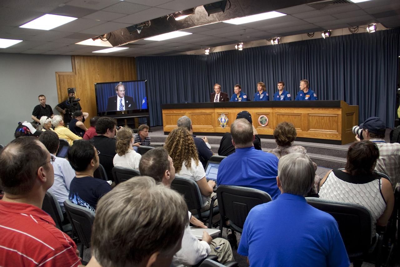 CAPE CANAVERAL, Fla. -- The crew of space shuttle Atlantis' STS-135 and Space Shuttle Program Flight, participates in a news conference in the Press Site auditorium at NASA's Kennedy Space Center in Florida on landing day. Seen here are NASA Commentator and Public Affairs Officer George Diller (left), STS-135 Commander Chris Ferguson, Mission Specialists Sandy Magnus and Rex Walheim, and Pilot Doug Hurley.        Securing the space shuttle fleet's place in history, Atlantis marked the 26th nighttime landing of NASA's Space Shuttle Program and the 78th landing at Kennedy. Main gear touchdown was at 5:57:00 a.m. EDT, followed by nose gear touchdown at 5:57:20 a.m., and wheelstop at 5:57:54 a.m. Atlantis and its crew delivered to the International Space Station the Raffaello multi-purpose logistics module packed with  more than 9,400 pounds of spare parts, equipment and supplies that will sustain station operations for the next year. STS-135 was the 33rd and final flight for Atlantis, which has spent 307 days in space, orbited Earth 4,848 times and traveled 125,935,769 miles. For more information, visit www.nasa.gov/mission_pages/shuttle/shuttlemissions/sts135/index.html. Photo credit: NASA/Jim Grossmann