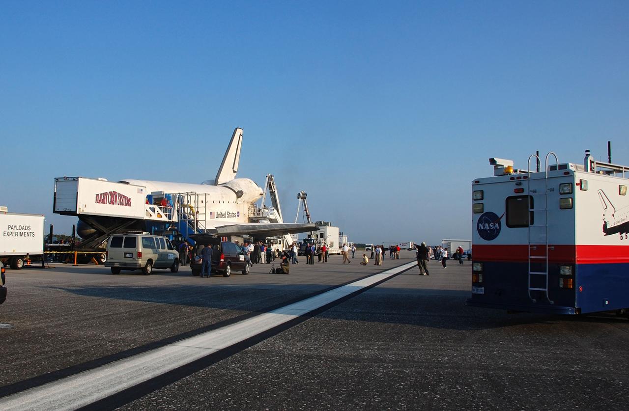 CAPE CANAVERAL, Fla. -- The Convoy Command Center vehicle is positioned near space shuttle Atlantis on the Shuttle Landing Facility (SLF) at NASA's Kennedy Space Center in Florida. The command vehicle is equipped to control critical communications between the crew still aboard Atlantis and the Launch Control Center. The team will monitor the health of the orbiter systems and direct convoy operations made up of about 40 vehicles, including 25 specially designed vehicles to assist the crew in leaving the shuttle, and prepare the vehicle for towing from the SLF to its processing hangar. Main gear touchdown was at 5:57:00 a.m. EDT, followed by nose gear touchdown at 5:57:20 a.m., and wheelstop at 5:57:54 a.m. On board are STS-135 Commander Chris Ferguson, Pilot Doug Hurley, and Mission Specialists Sandra Magnus and Rex Walheim.      Securing the space shuttle fleet's place in history, Atlantis marks the 26th nighttime landing of NASA's Space Shuttle Program and the 78th landing at Kennedy. Atlantis and its crew delivered to the International Space Station the Raffaello multi-purpose logistics module packed with more than 9,400 pounds of spare parts, equipment and supplies that will sustain station operations for the next year. STS-135 is the 33rd and final flight for Atlantis and the final mission of the Space Shuttle Program. For more information, visit www.nasa.gov/mission_pages/shuttle/shuttlemissions/sts135/index.html. Photo credit: NASA/Ben Smegelsky