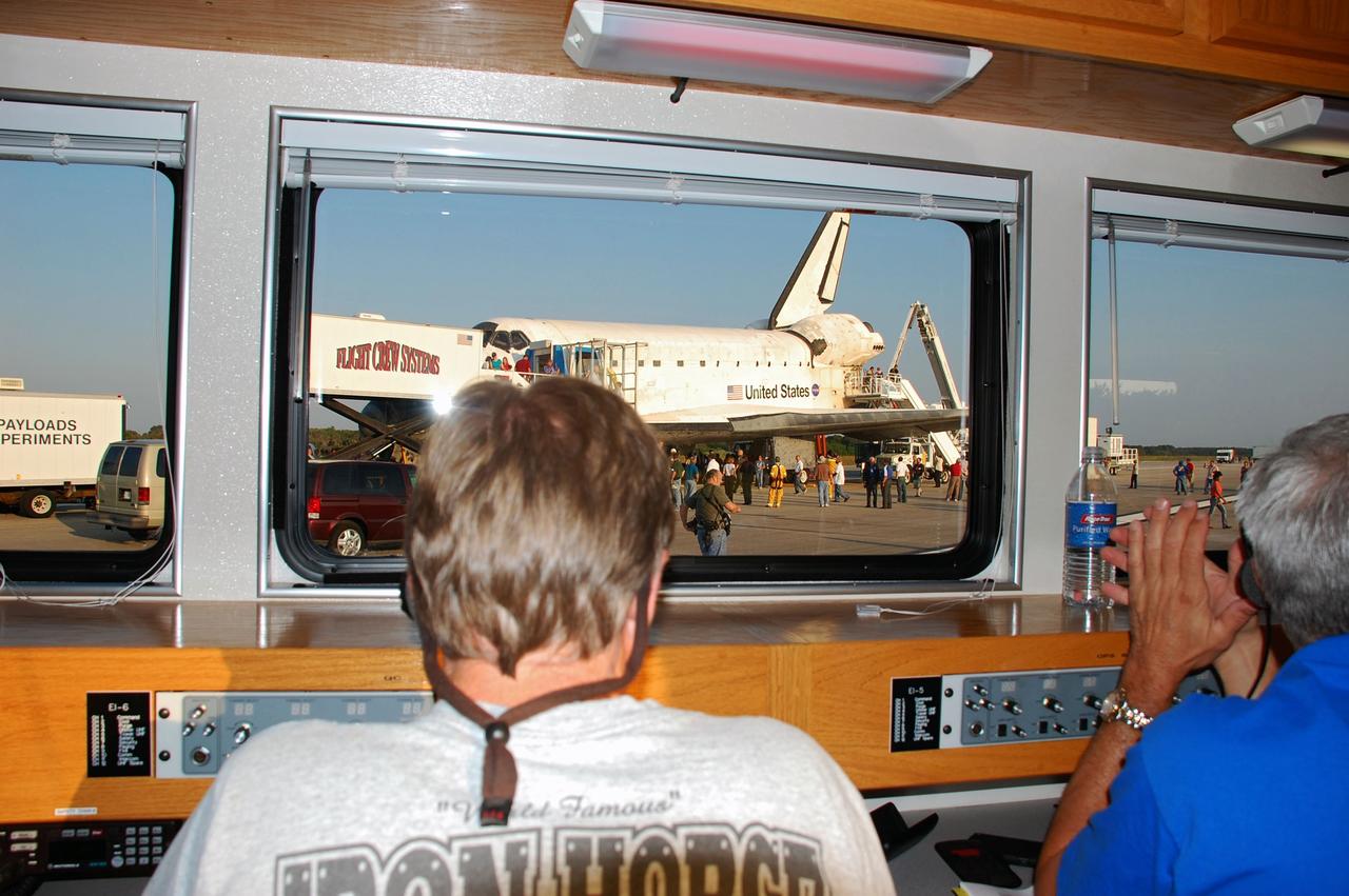 CAPE CANAVERAL, Fla. -- The Convoy Command Center vehicle is positioned near space shuttle Atlantis on the Shuttle Landing Facility (SLF) at NASA's Kennedy Space Center in Florida. The command vehicle is equipped to control critical communications between the crew still aboard Atlantis and the Launch Control Center. The team will monitor the health of the orbiter systems and direct convoy operations made up of about 40 vehicles, including 25 specially designed vehicles to assist the crew in leaving the shuttle, and prepare the vehicle for towing from the SLF to its processing hangar. Main gear touchdown was at 5:57:00 a.m. EDT, followed by nose gear touchdown at 5:57:20 a.m., and wheelstop at 5:57:54 a.m. On board are STS-135 Commander Chris Ferguson, Pilot Doug Hurley, and Mission Specialists Sandra Magnus and Rex Walheim.    Securing the space shuttle fleet's place in history, Atlantis marks the 26th nighttime landing of NASA's Space Shuttle Program and the 78th landing at Kennedy. Atlantis and its crew delivered to the International Space Station the Raffaello multi-purpose logistics module packed with more than 9,400 pounds of spare parts, equipment and supplies that will sustain station operations for the next year. STS-135 is the 33rd and final flight for Atlantis and the final mission of the Space Shuttle Program. For more information, visit www.nasa.gov/mission_pages/shuttle/shuttlemissions/sts135/index.html. Photo credit: NASA/Ben Smegelsky