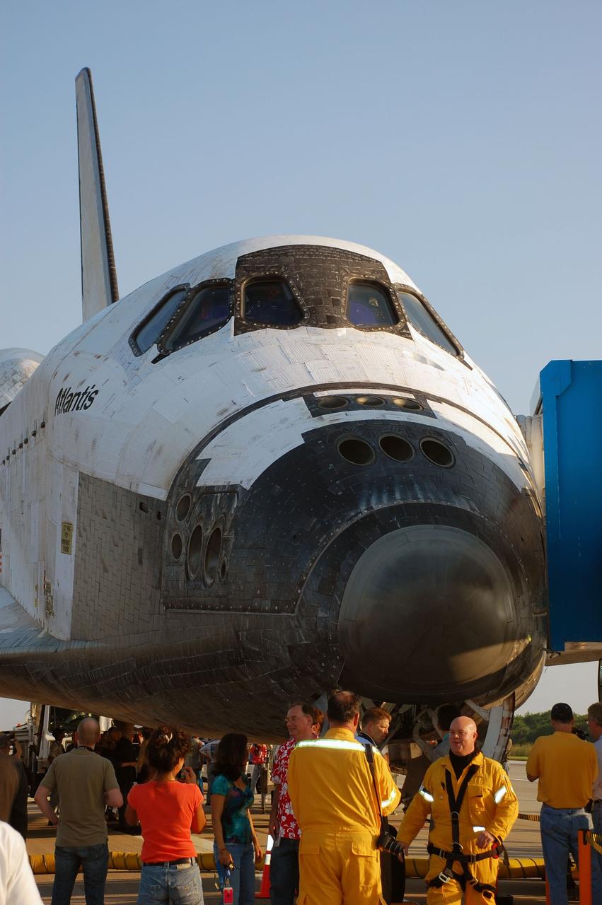 CAPE CANAVERAL, Fla. -- Employees admire space shuttle Atlantis as the landing convoy crew makes the vehicle safe for towing to its processing hangar at NASA's Kennedy Space Center in Florida. Atlantis' final return to Earth on the Shuttle Landing Facility's Runway 15 at NASA's Kennedy Space Center in Florida occurred at 5:57 a.m. EDT completing the 13-day, 5.2-million-mile STS-135 mission.       Securing the space shuttle fleet's place in history, Atlantis marks the 26th nighttime landing of NASA's Space Shuttle Program and the 78th landing at Kennedy. Atlantis and its crew delivered to the International Space Station the Raffaello multi-purpose logistics module packed with more than 9,400 pounds of spare parts, equipment and supplies that will sustain station operations for the next year. STS-135 is the 33rd and final flight for Atlantis and the final mission of the Space Shuttle Program. For more information, visit www.nasa.gov/mission_pages/shuttle/shuttlemissions/sts135/index.html. Photo credit: NASA/Ben Smegelsky