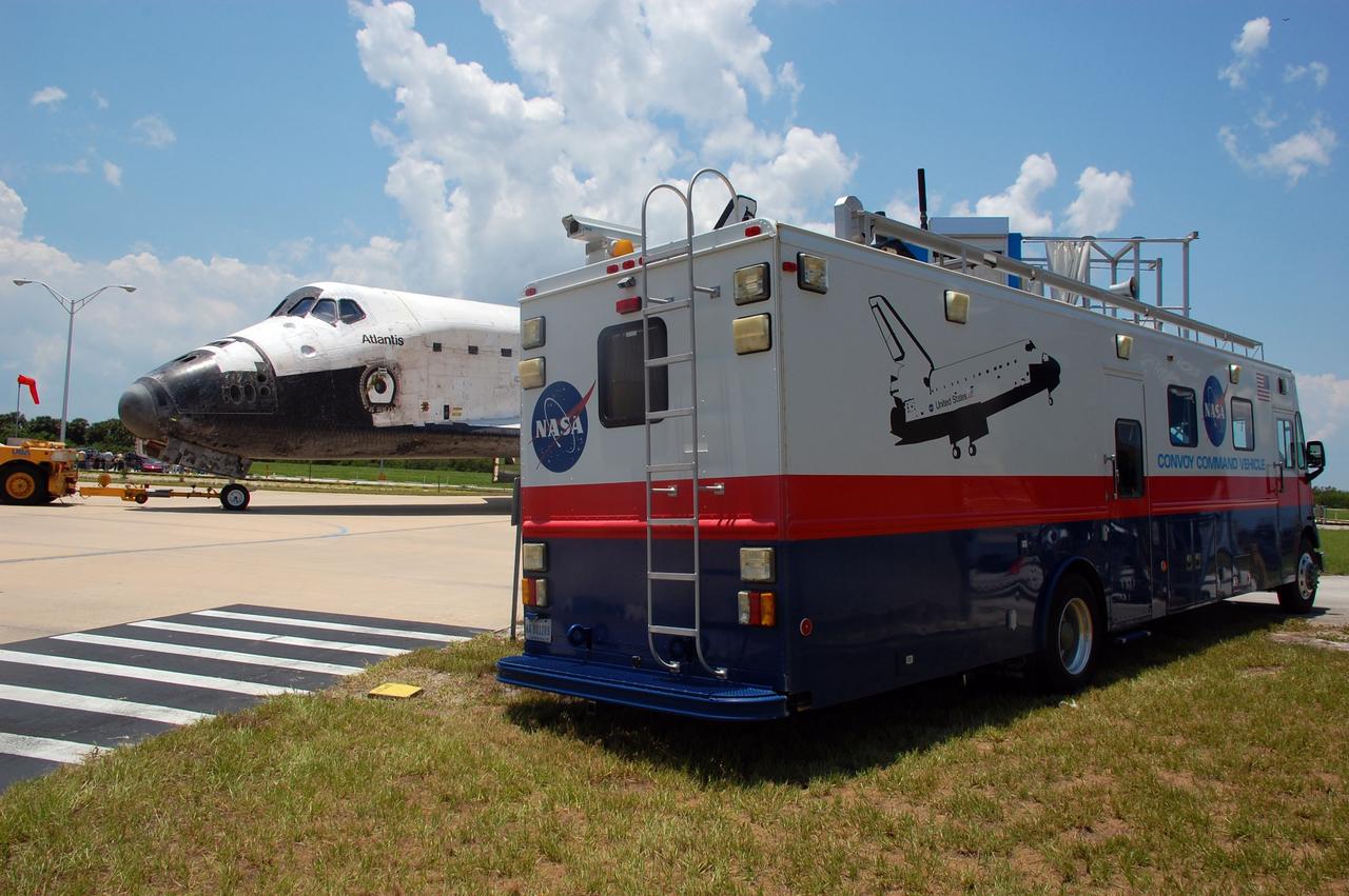 CAPE CANAVERAL, Fla. -- The Convoy Command Center vehicle is positioned near space shuttle Atlantis outside Orbiter Processing Facility-2 at NASA's Kennedy Space Center in Florida. The command vehicle is equipped to control critical communications between the crew still aboard Atlantis and the Launch Control Center. The Convoy Command Center vehicle is part of about 40 vehicles, including 25 specially designed vehicles to assist the crew in leaving the shuttle, and prepare the vehicle for towing from the SLF to its processing hangar. Main gear touchdown was at 5:57:00 a.m. EDT, followed by nose gear touchdown at 5:57:20 a.m., and wheelstop at 5:57:54 a.m. On board were STS-135 Commander Chris Ferguson, Pilot Doug Hurley, and Mission Specialists Sandra Magnus and Rex Walheim.    Securing the space shuttle fleet's place in history, Atlantis marks the 26th nighttime landing of NASA's Space Shuttle Program and the 78th landing at Kennedy. Atlantis and its crew delivered to the International Space Station the Raffaello multi-purpose logistics module packed with more than 9,400 pounds of spare parts, equipment and supplies that will sustain station operations for the next year. STS-135 is the 33rd and final flight for Atlantis and the final mission of the Space Shuttle Program. For more information, visit www.nasa.gov/mission_pages/shuttle/shuttlemissions/sts135/index.html. Photo credit: NASA/Ben Smegelsky
