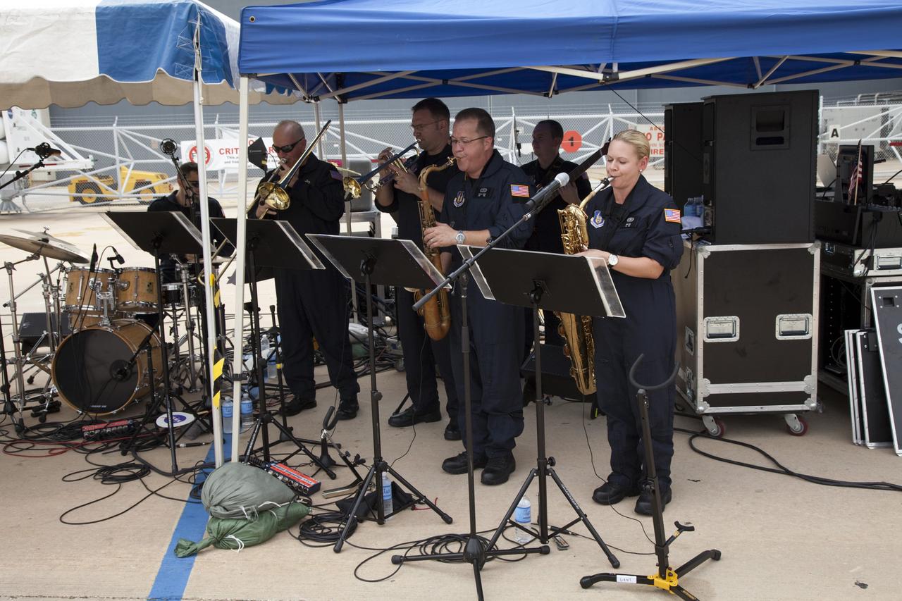 CAPE CANAVERAL, Fla. -- At NASA's Kennedy Space Center in Florida, The Band of the United States Air Force Reserve provides entertainment at an employee appreciation event for the thousands of workers who have processed, launched and landed America's space shuttles for more than three decades. Following the successful STS-135 mission, space shuttle Atlantis was parked at the celebration site for photo opportunities. STS-135 secured the space shuttle fleet's place in history and brought a close to NASA's Space Shuttle Program.                     STS-135 delivered spare parts, equipment and supplies to the International Space Station. STS-135 was the 33rd and final flight for Atlantis, which has spent 307 days in space, orbited Earth 4,848 times and traveled 125,935,769 miles. For more information visit, www.nasa.gov/mission_pages/shuttle/shuttlemissions/sts135/index.html. Photo credit: NASA/Frankie Martin
